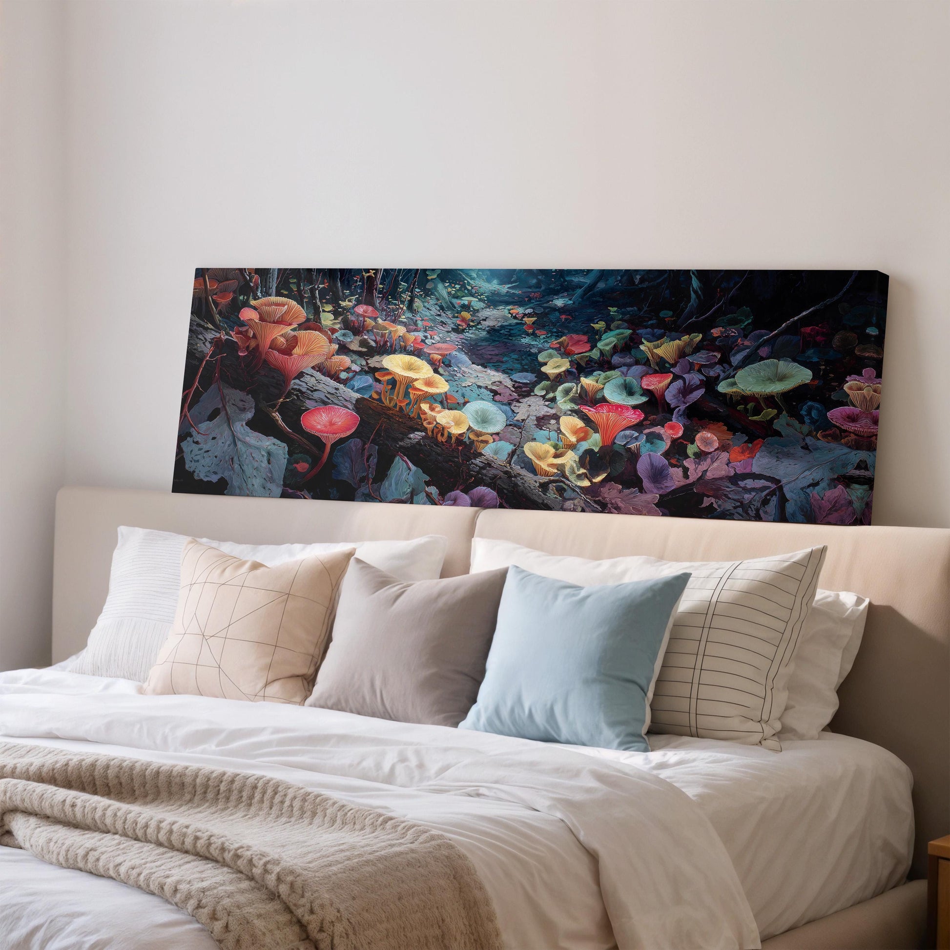 a large, colorful painting of a flower garden hanging above a bed with white pillows and a gray blanket.