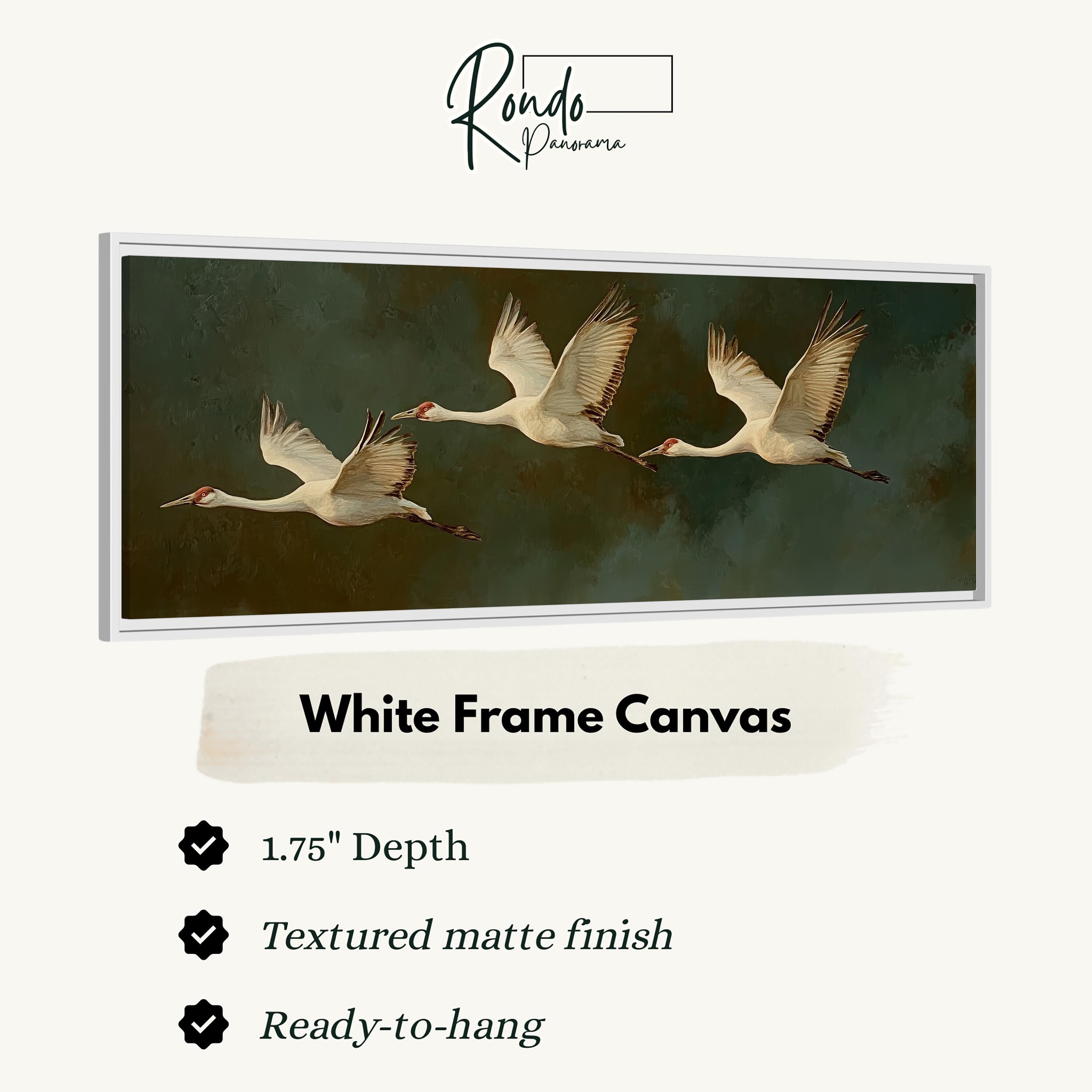 a white frame canvas with a painting of three swans in flight. The canvas has a 1.75" depth and is textured with a matte finish. It is ready to hang.
