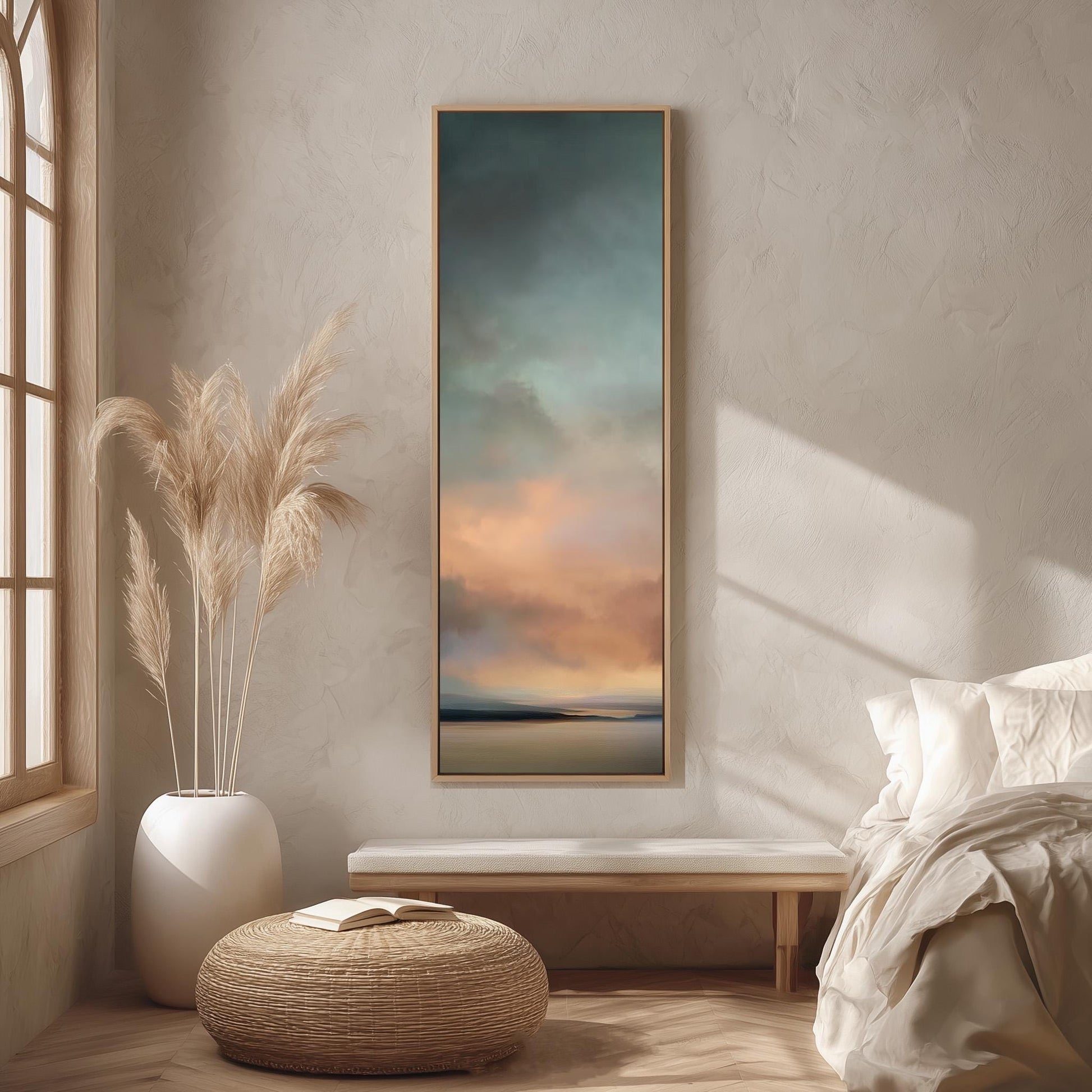 a serene bedroom scene with a large window, a painting of a sunset, a white bench, a woven ottoman, and a potted plant.