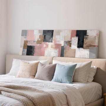 a large abstract painting hanging above a bed with white sheets and pillows.