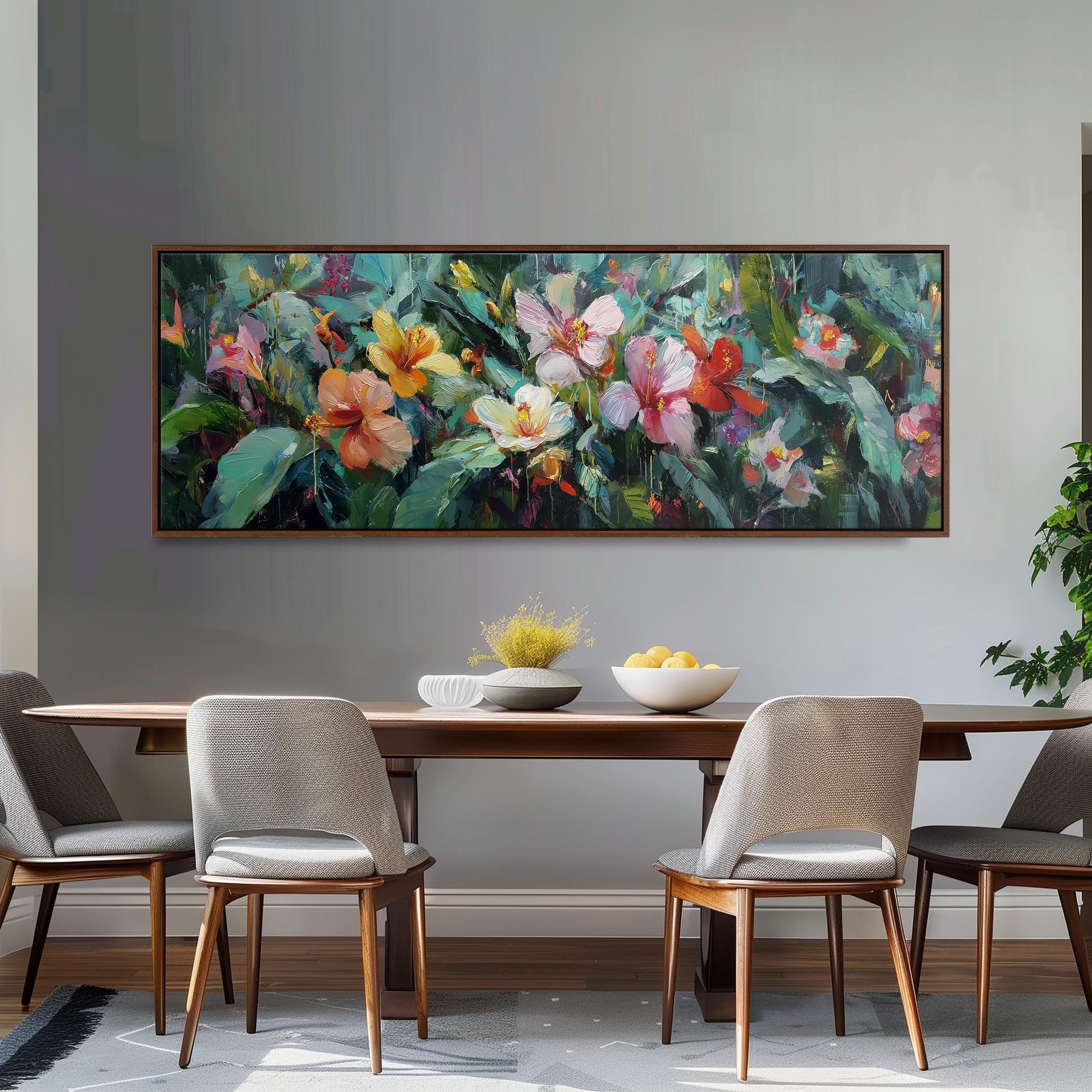 a dining room with a large painting of colorful flowers hanging on the wall above a wooden dining table with four chairs. The table is set with a bowl of fruit and a vase of flowers, creating a welcoming and vibrant atmosphere.