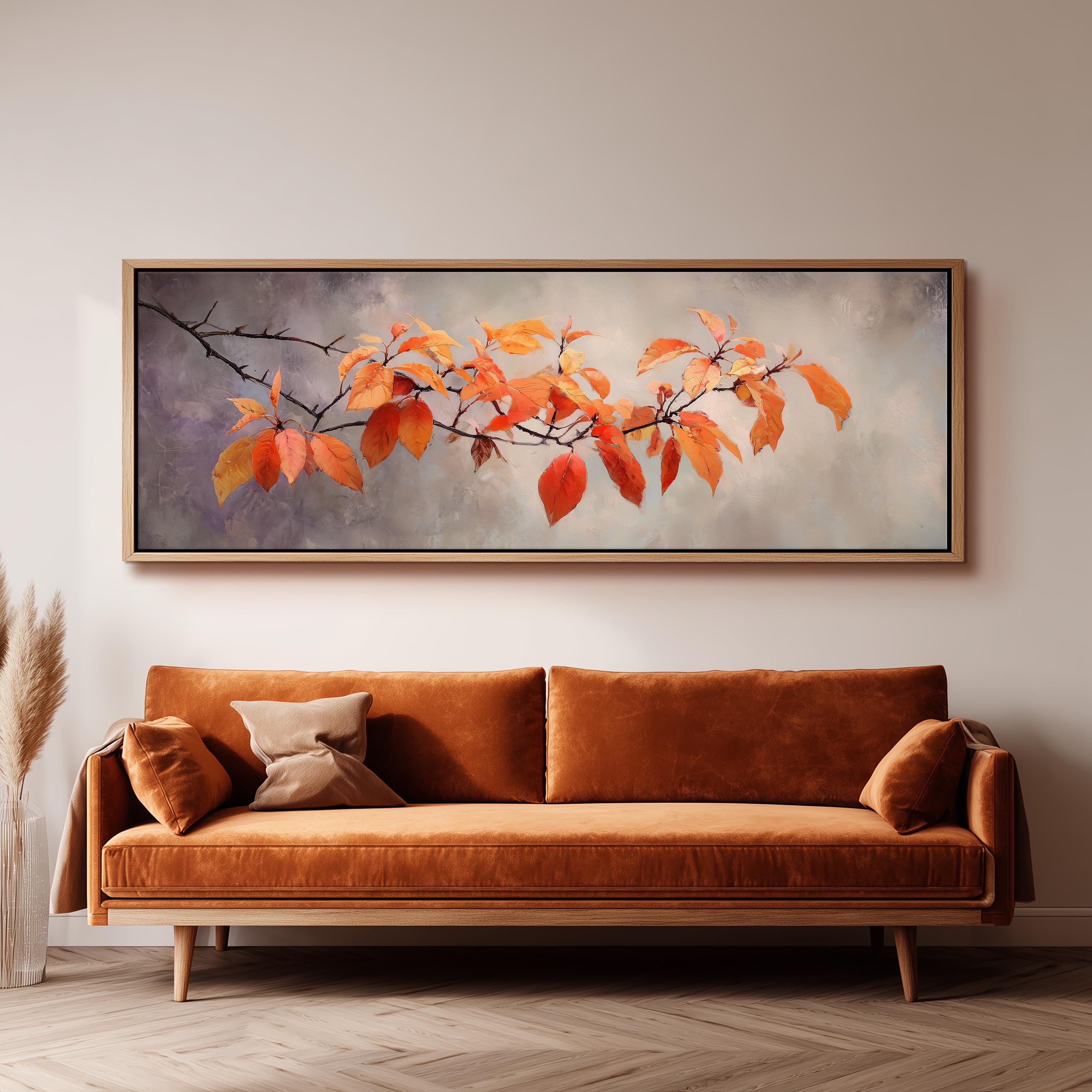 a large painting of a branch with orange leaves hanging on a wall above a brown sofa.