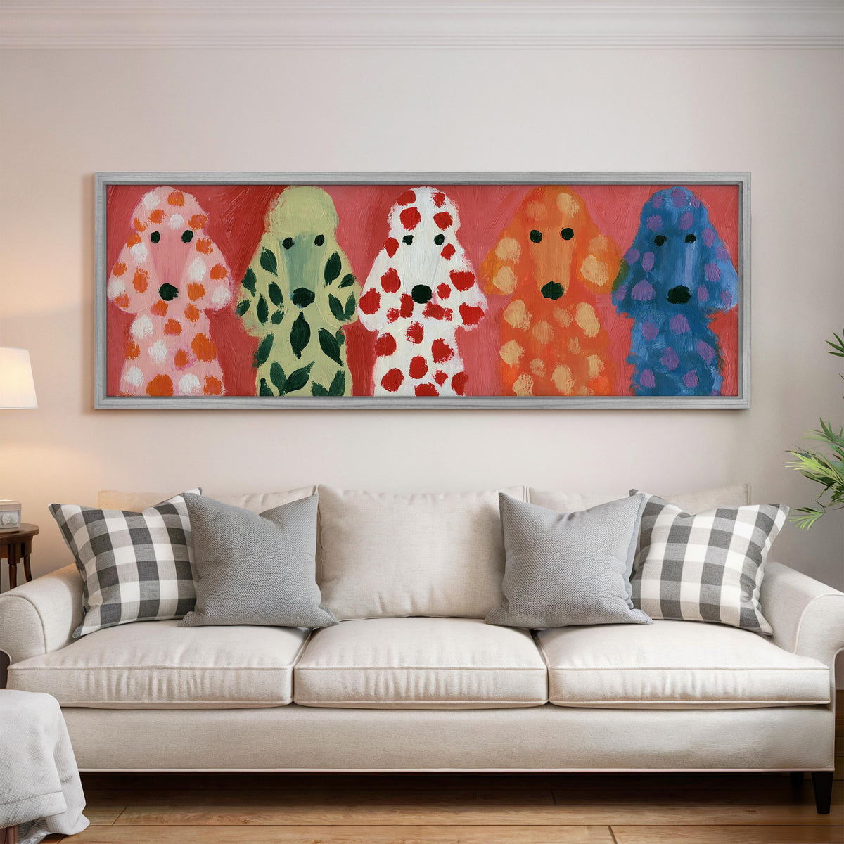 Five colorful poodles panoramic canvas print above a white sofa in a bright living room