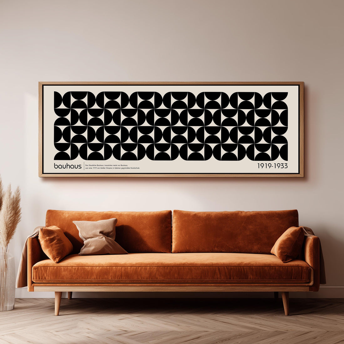 a modern black and white checkered sofa with a brown throw pillow, set against a dark wall with a framed abstract art piece above it.