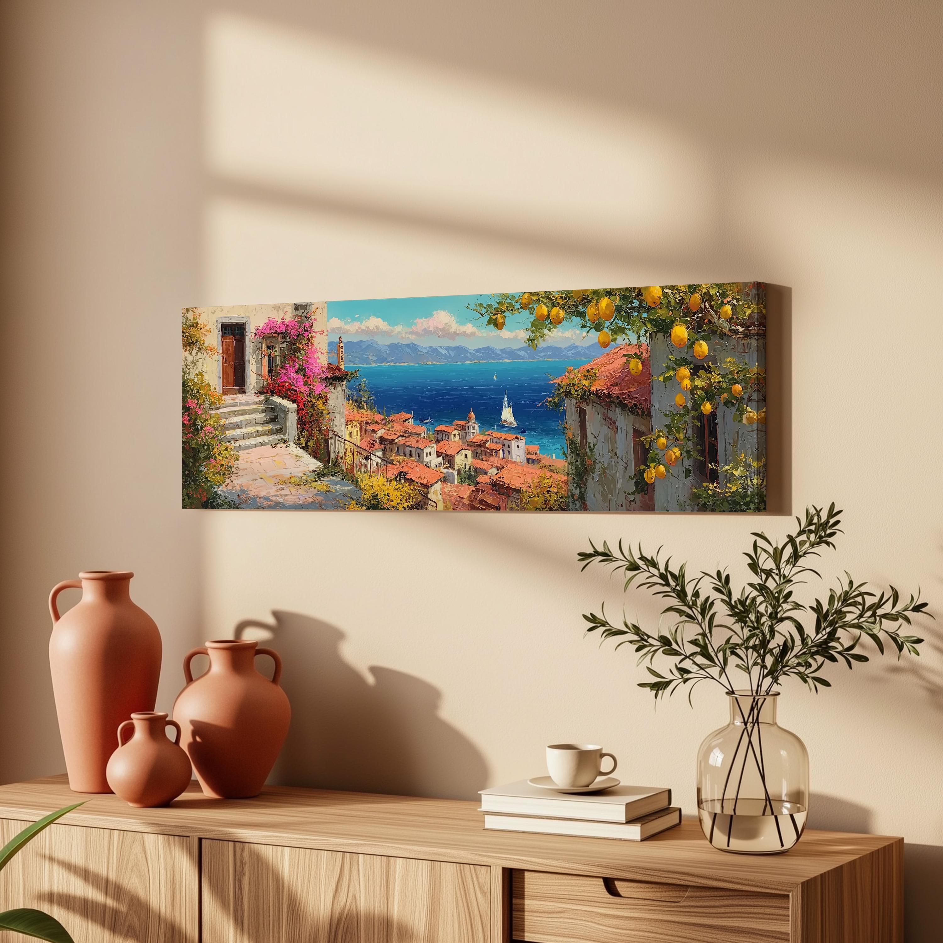 a coastal town with a view of the sea, a sailboat, and a clear blue sky with fluffy clouds.