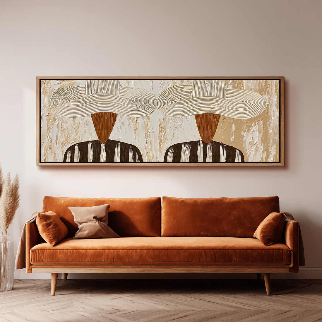 Two folk figures in wide textured hats long horizontal canvas print above a sofa in a living room