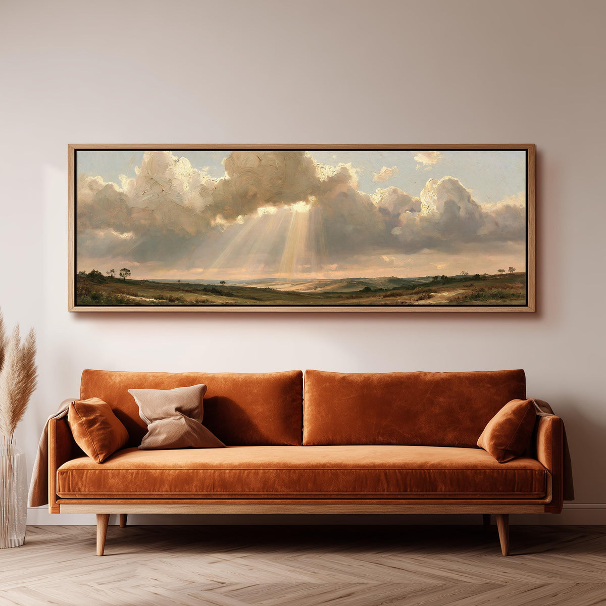 Sunbeams breaking through clouds over plains panoramic canvas print above a sofa in a living room
