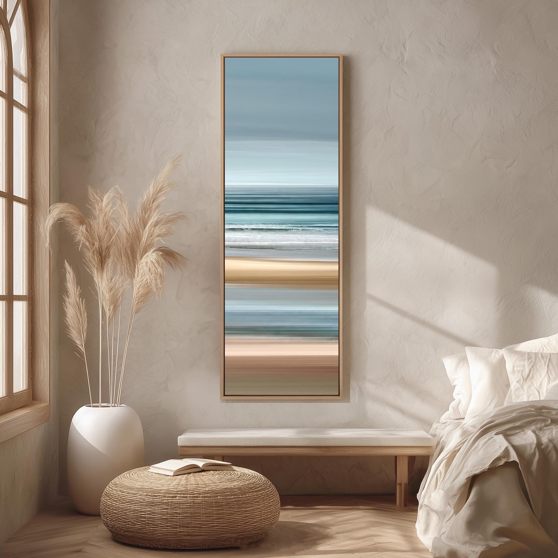 a serene bedroom scene with a large window, a painting of a beach, a white bench, a woven ottoman, and a potted plant.