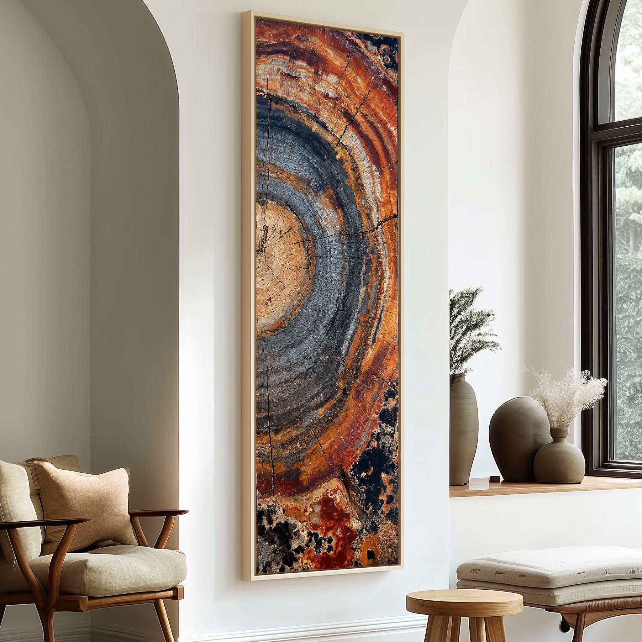 a large, colorful abstract painting hanging on a white wall, with a wooden chair and a small table in the foreground.