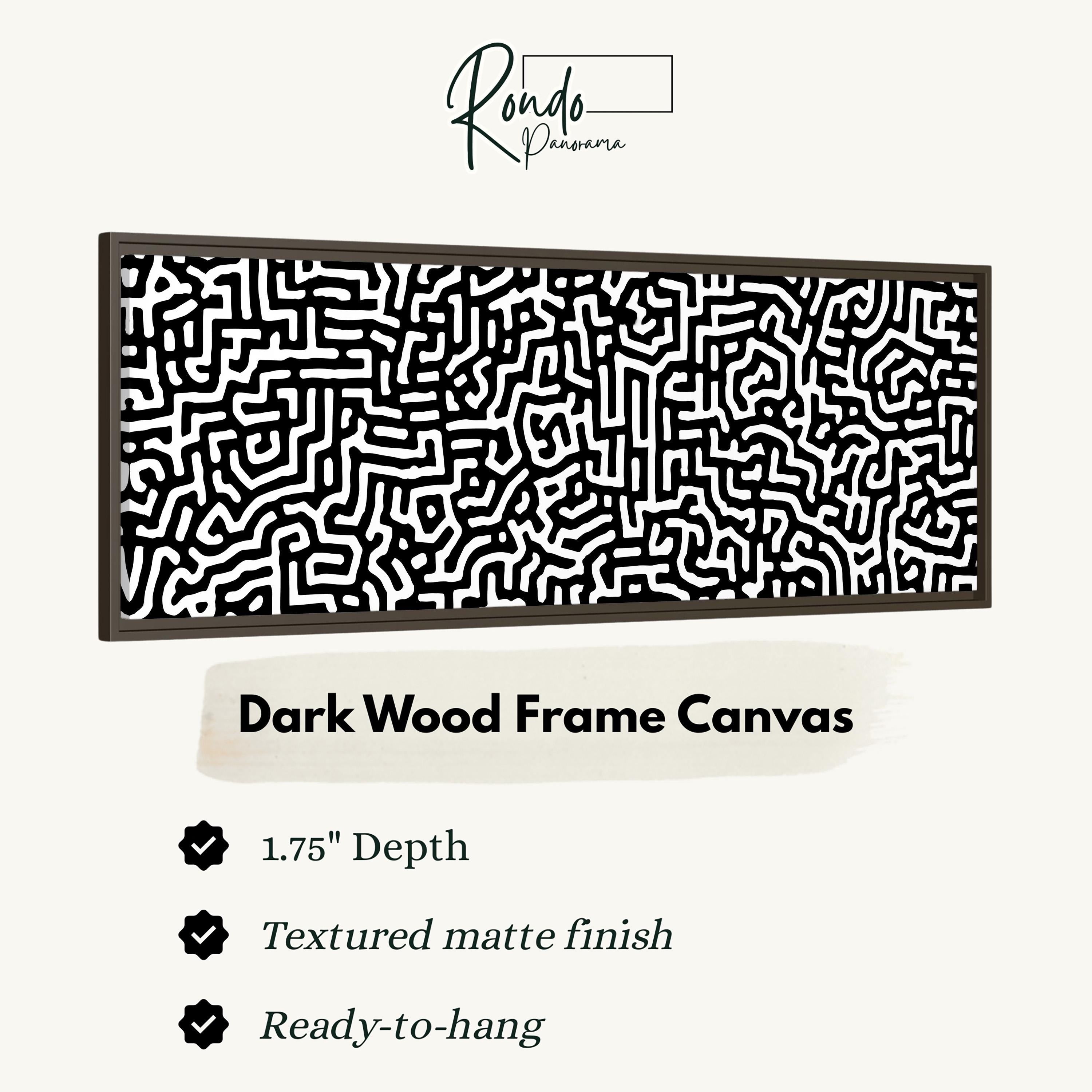a dark wood frame canvas with a black and white maze pattern.