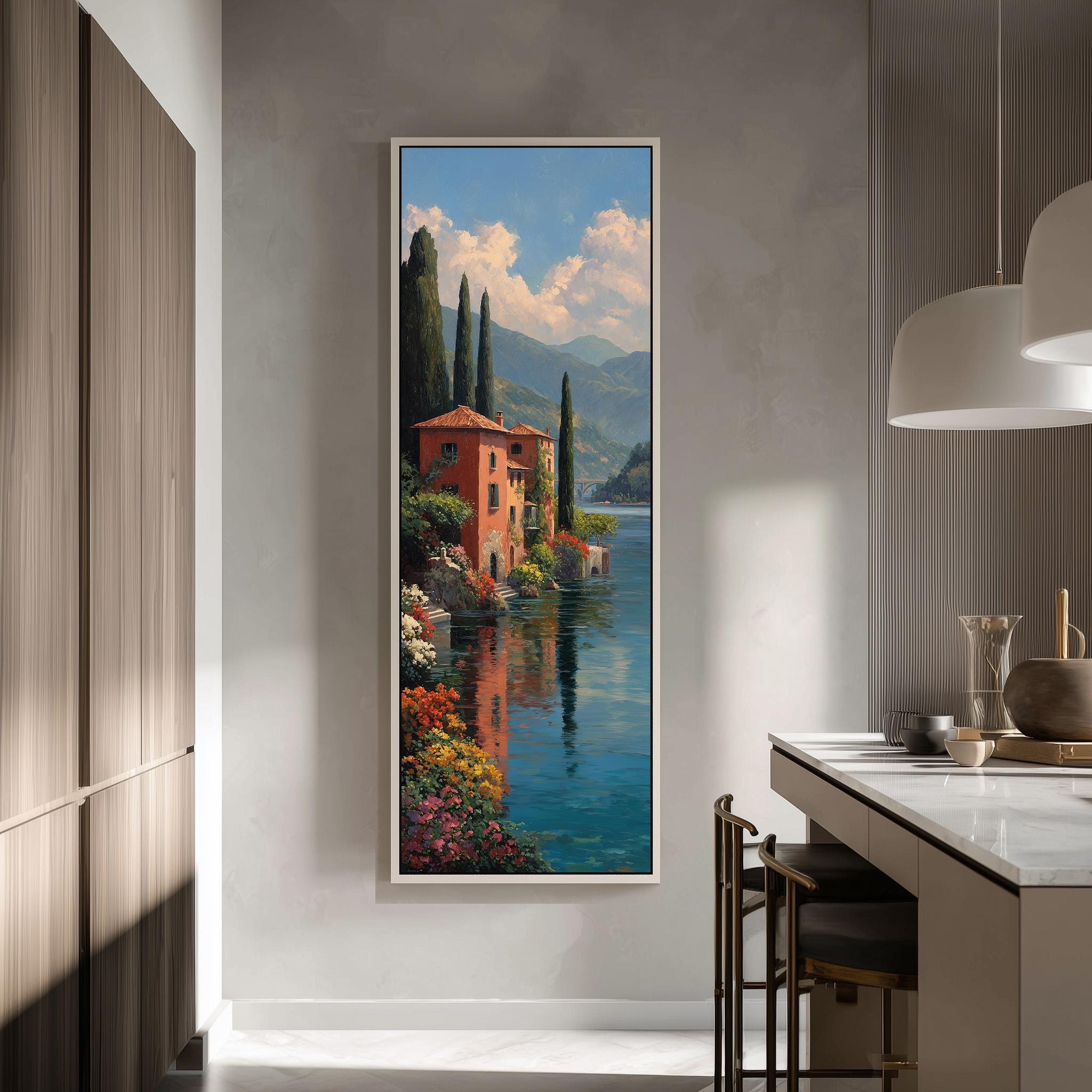a large, framed painting of a picturesque Italian landscape, depicting a red-roofed building surrounded by lush greenery and a serene body of water.