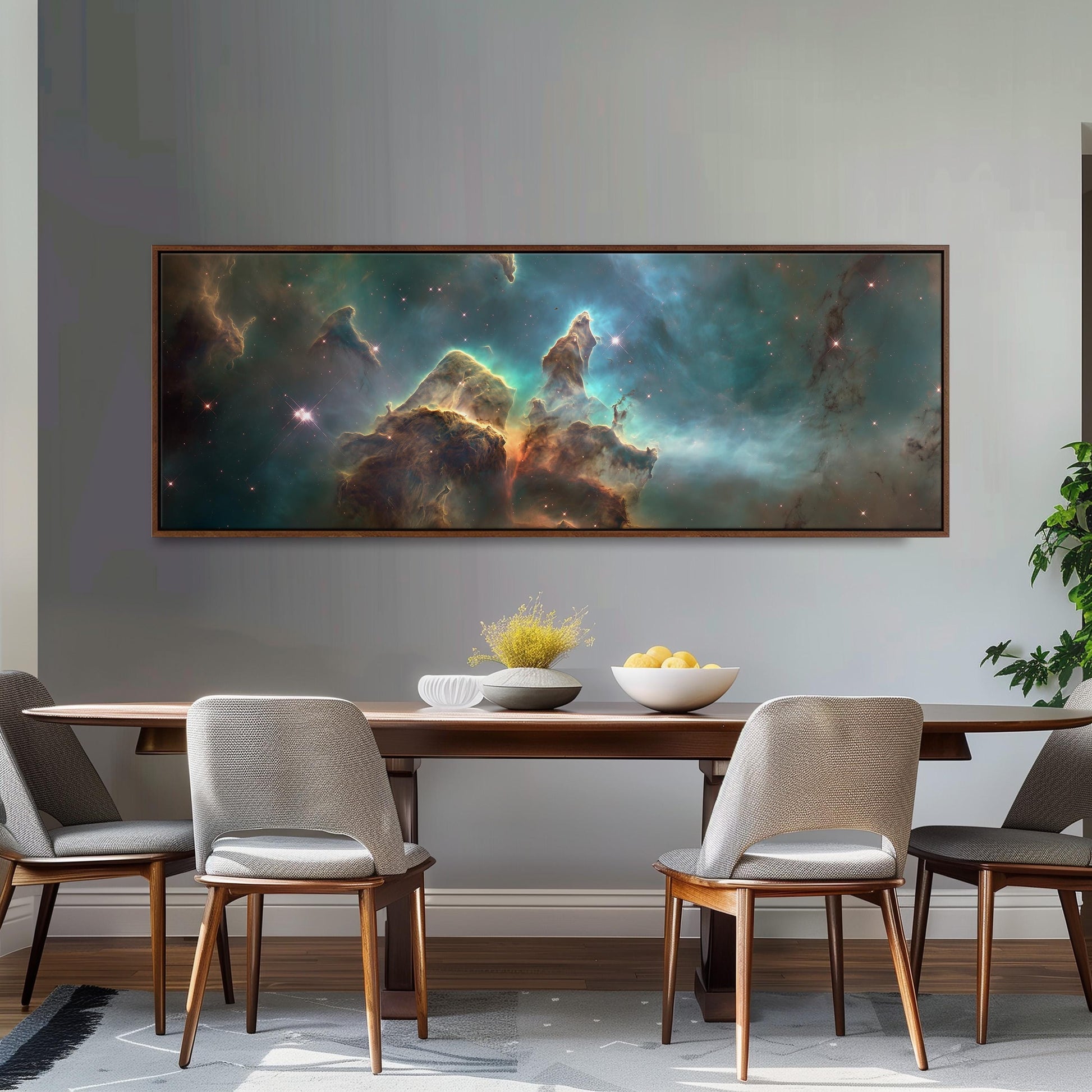 a large, framed painting of a nebula hanging on a wall above a wooden dining table with four chairs. The painting depicts a vibrant, colorful nebula with swirling clouds of gas and dust.