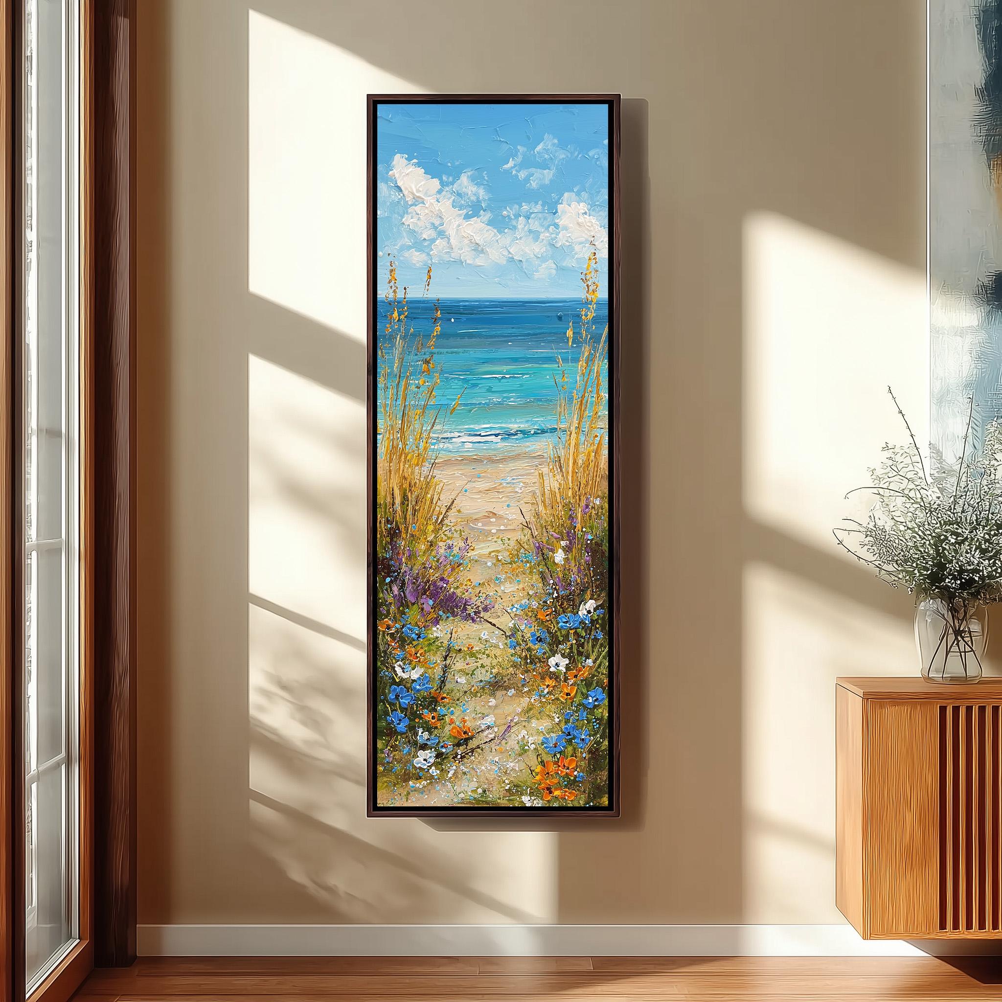 a large framed painting of a beach scene with a path leading to the ocean, surrounded by tall grasses and flowers.