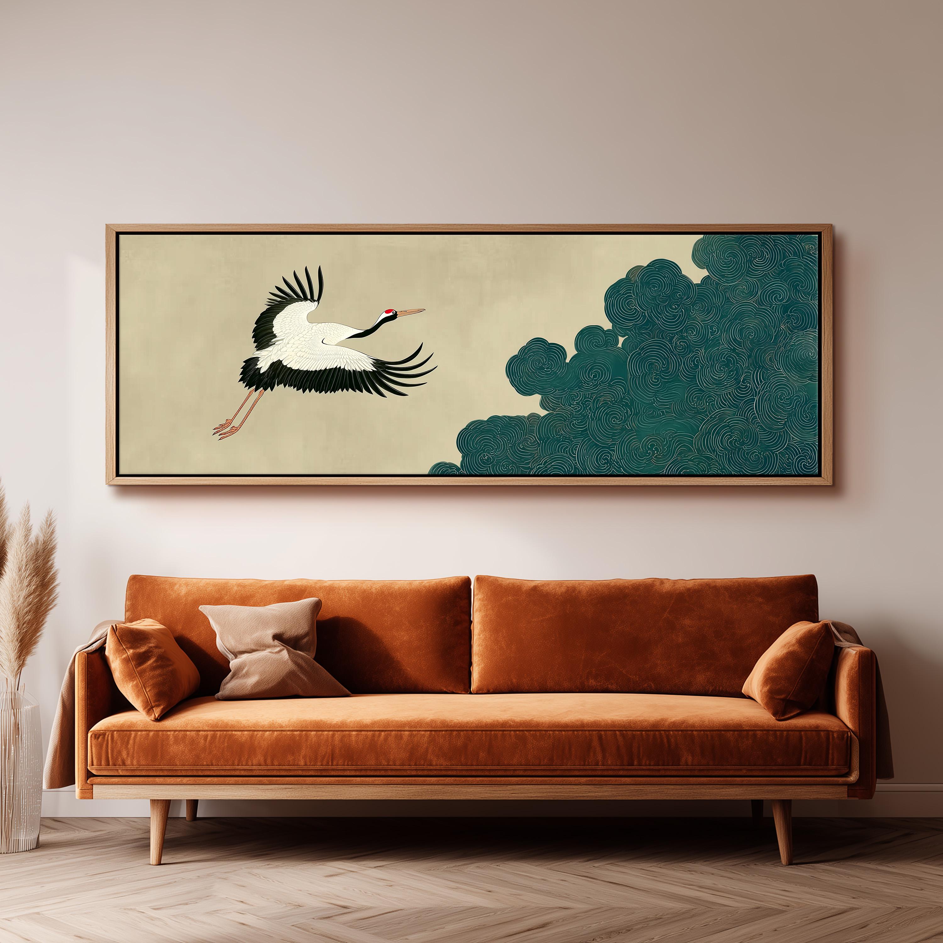 a large, framed artwork of a crane in flight above a brown sofa in a living room setting.