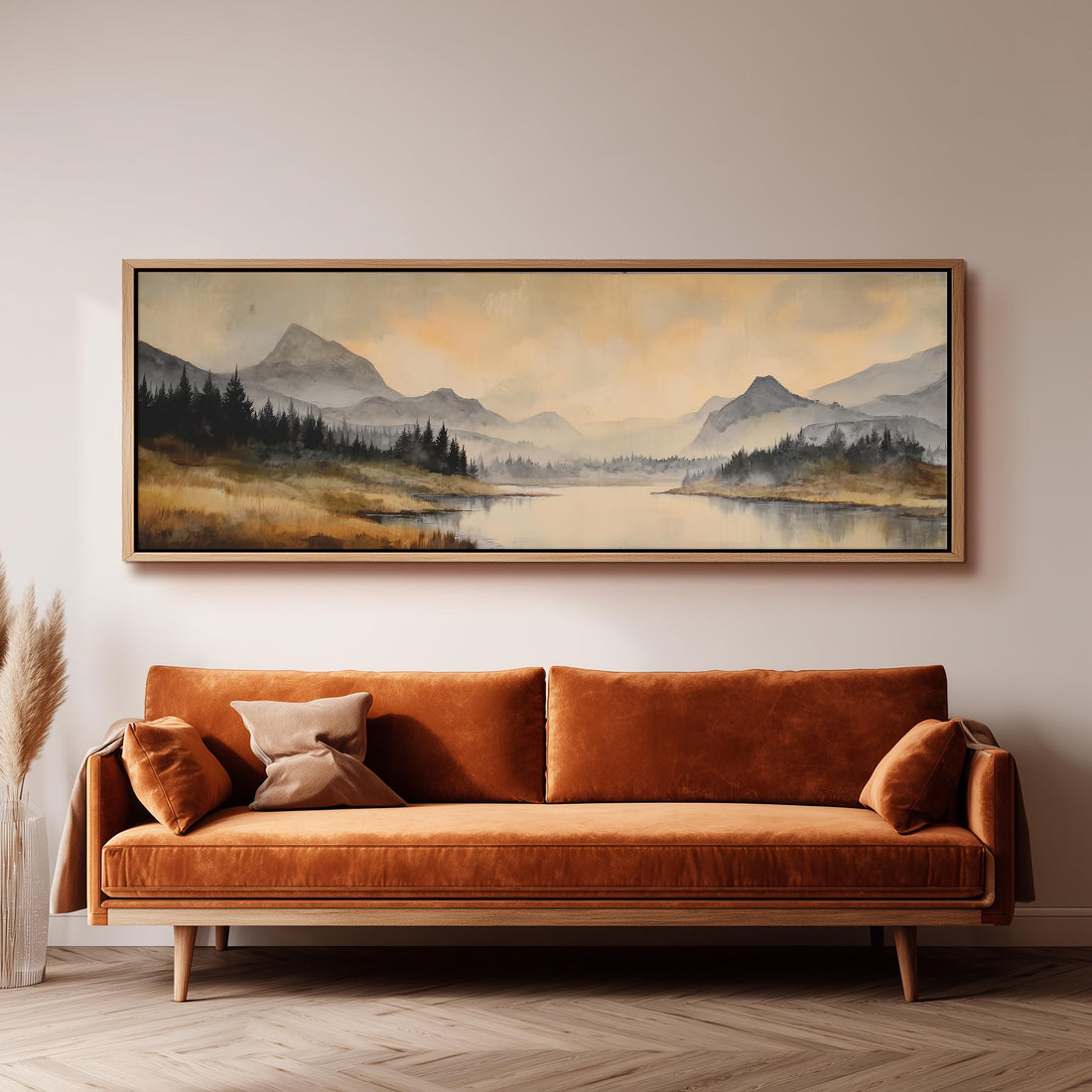 a dining room with a large painting of a mountain landscape hanging on the wall above a wooden dining table with four chairs. The painting depicts a serene mountain scene with a lake and trees in the background.