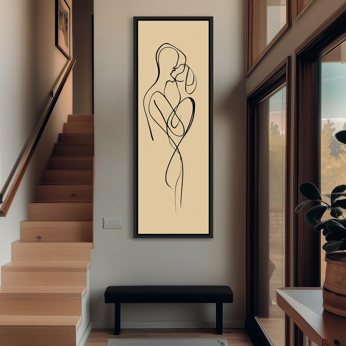 a framed abstract art piece depicting a couple embracing, hanging on a wall in a room with a wooden cabinet and a vase of flowers.