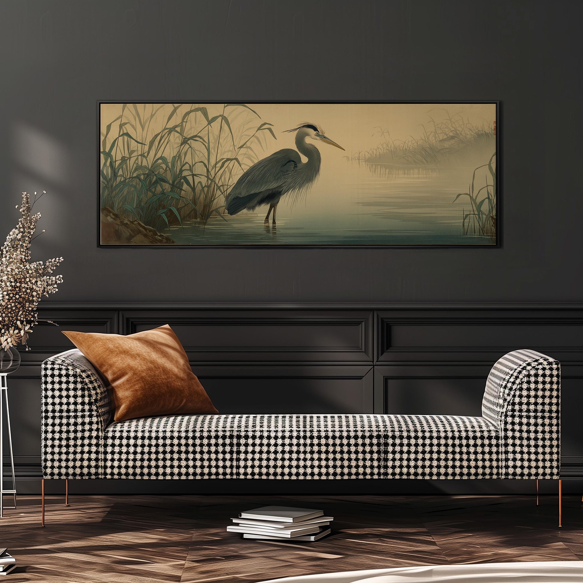 a large painting of a heron standing in a body of water, hanging on a wall above a black and white checkered sofa.