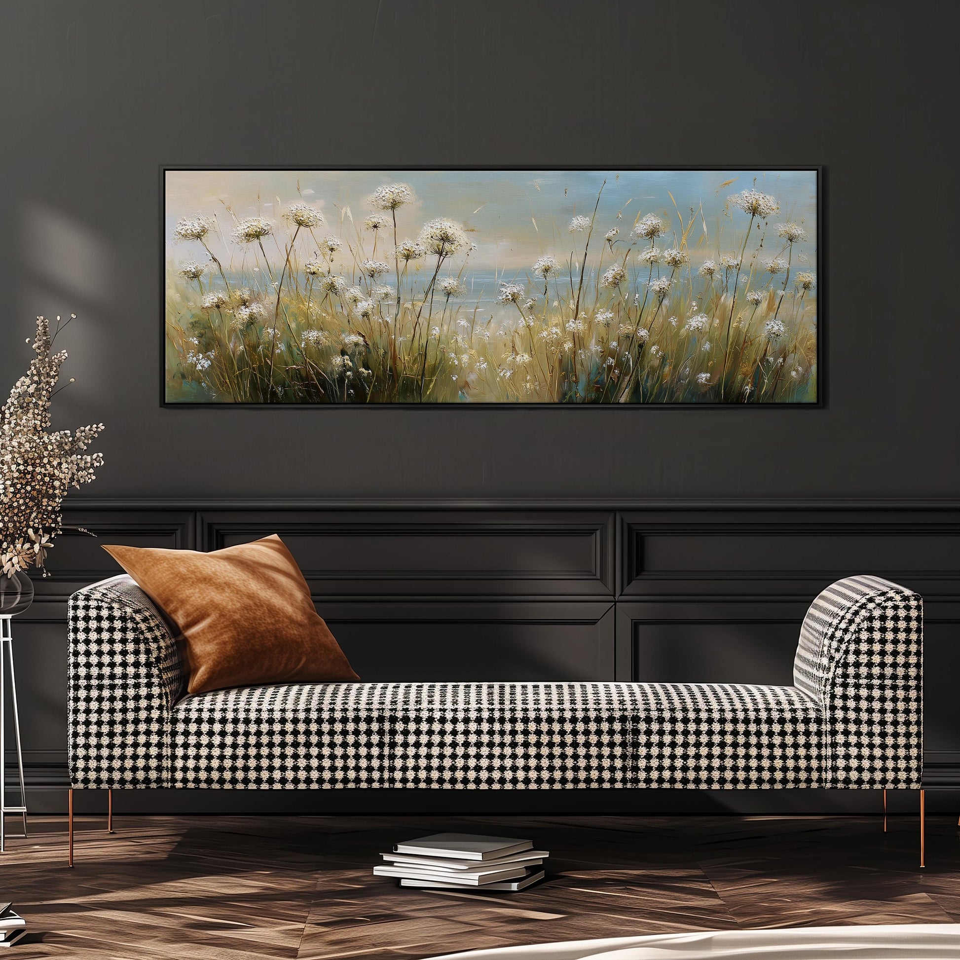 a black and white checkered sofa with a brown throw pillow, set against a dark wall with a large painting of a field of flowers hanging above it.