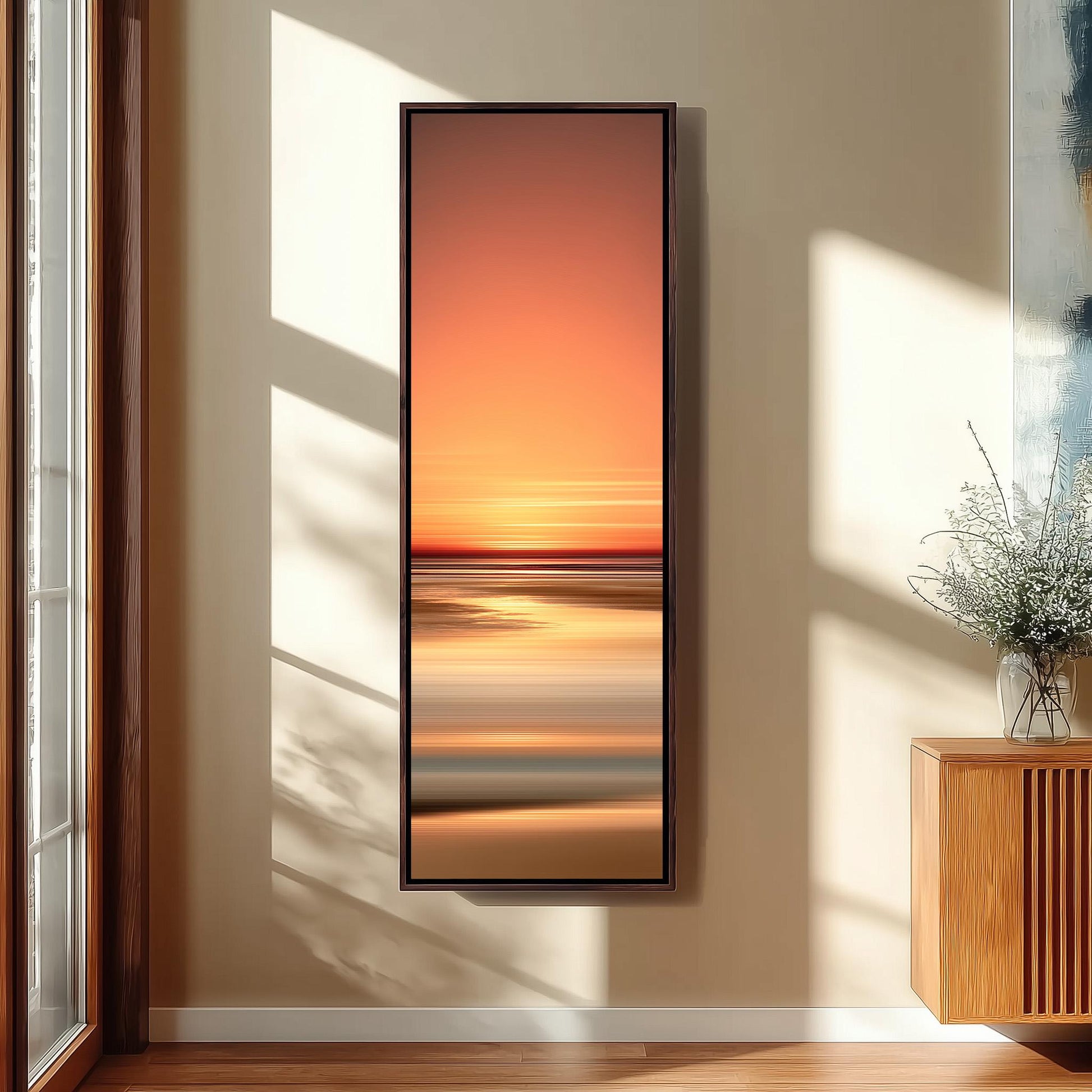a large, rectangular painting hanging on a wall, depicting a sunset over a beach.