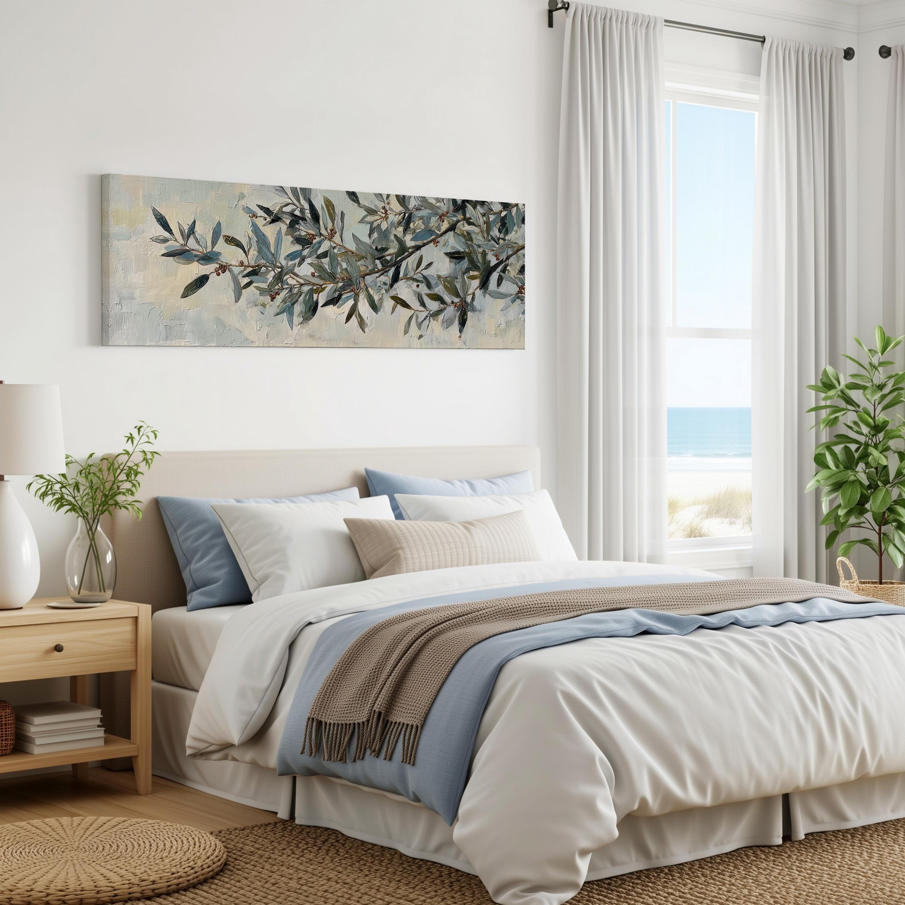 a serene and well-decorated bedroom with a large bed, a painting of leaves on the wall, and a window overlooking the ocean.