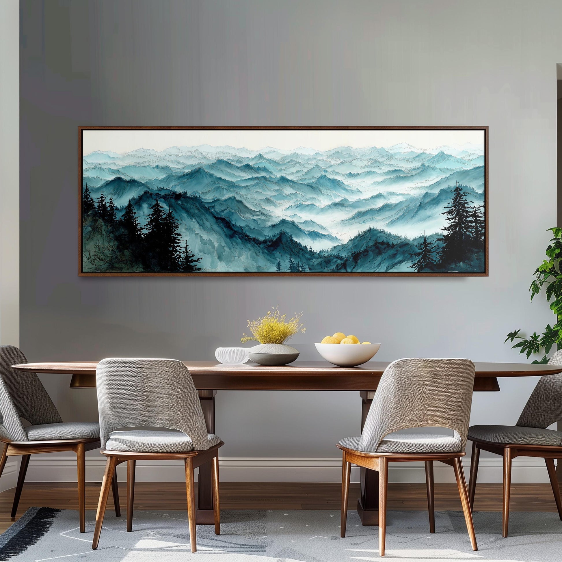 a dining room with a large painting of a mountain landscape hanging on the wall above a wooden dining table with four chairs. The painting depicts a serene mountain scene with trees and a misty, hazy atmosphere.