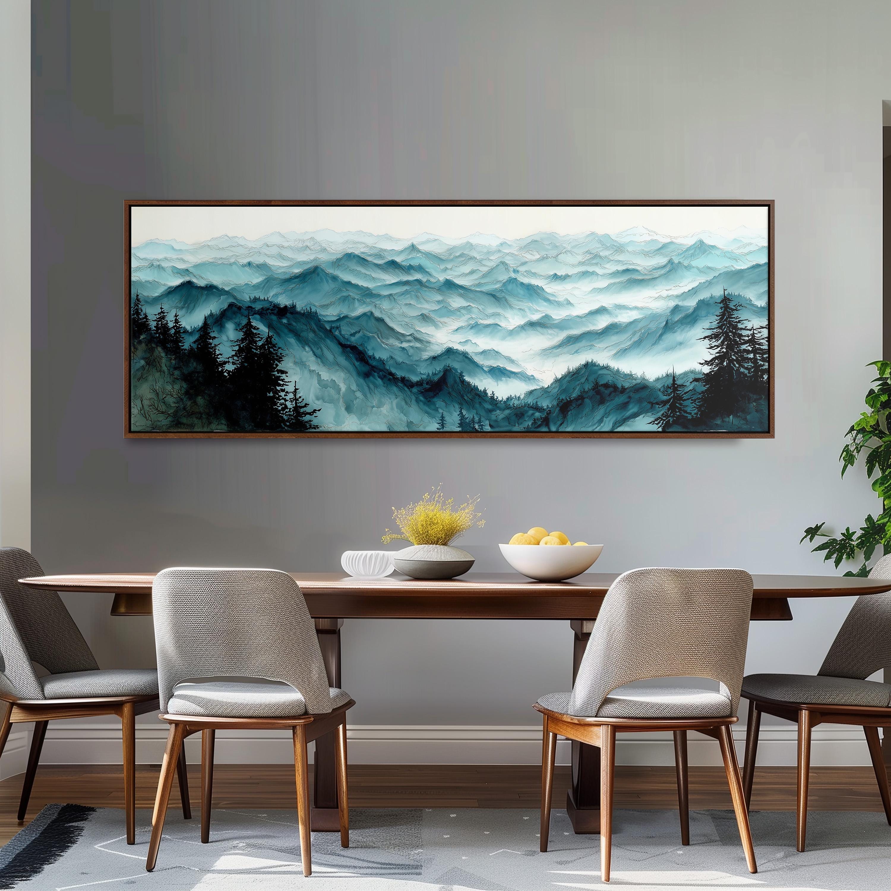a dining room with a large painting of a mountain landscape hanging on the wall above a wooden dining table with four chairs. The painting depicts a serene mountain scene with trees and a misty, hazy atmosphere.