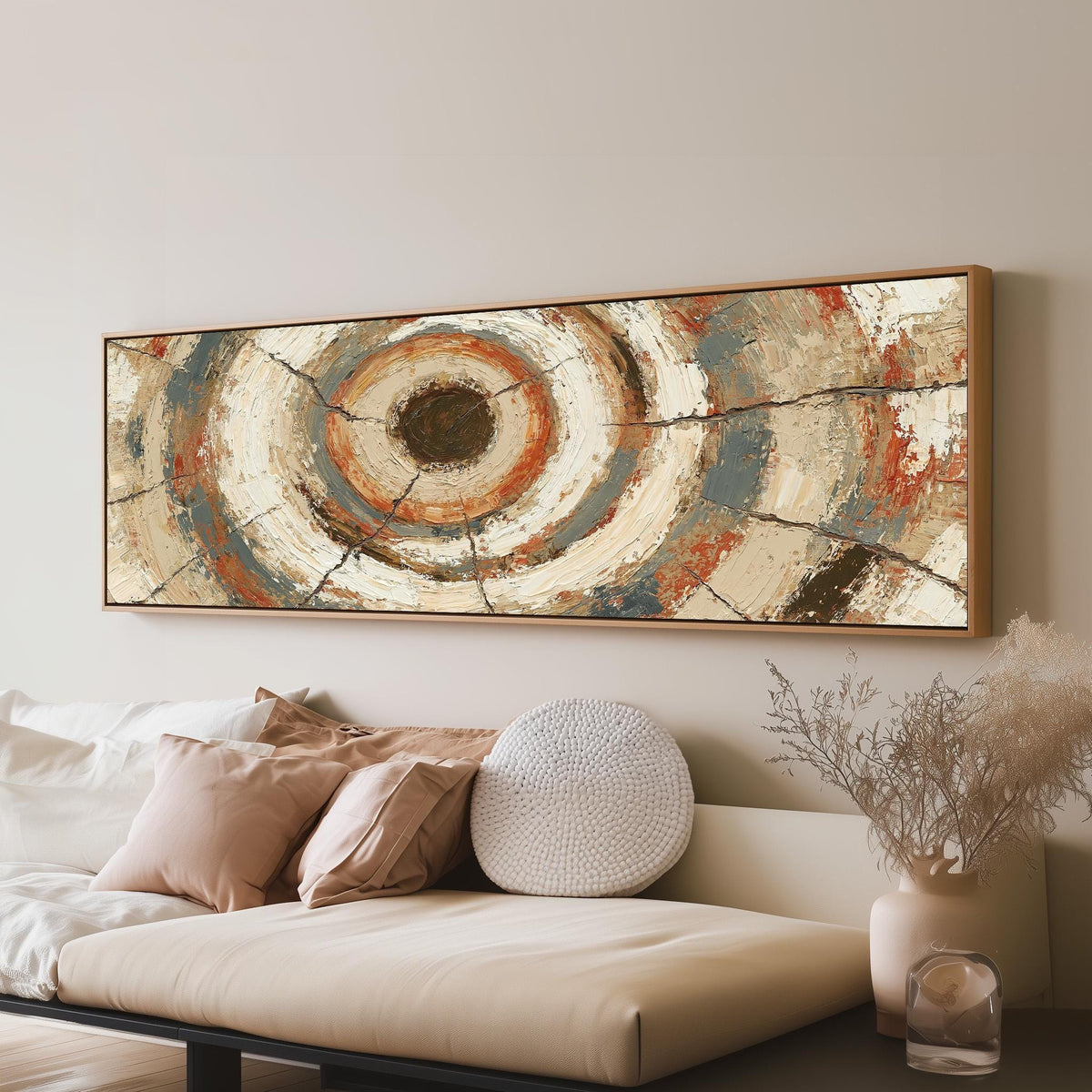 Rust and navy textured tree ring long horizontal canvas print above a sofa in a living room