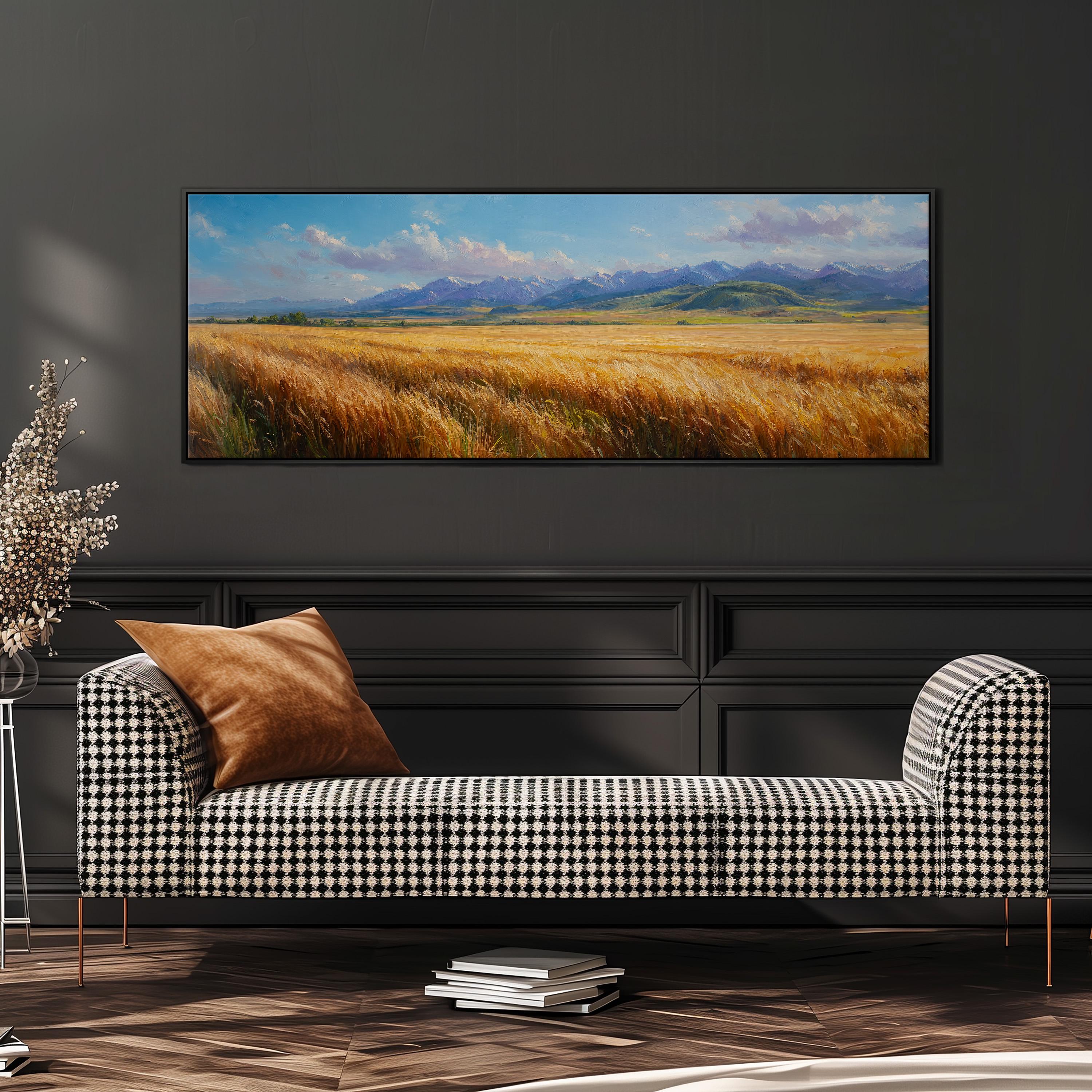 a large, framed painting of a field of golden wheat against a backdrop of mountains, hanging on a wall above a black and white checkered sofa.