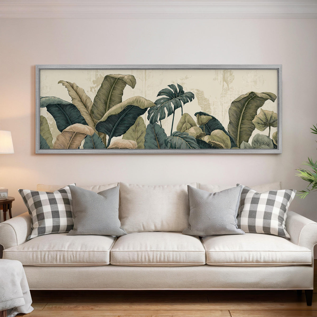 Vintage tropical leaves panoramic canvas print above a white sofa in a bright living room