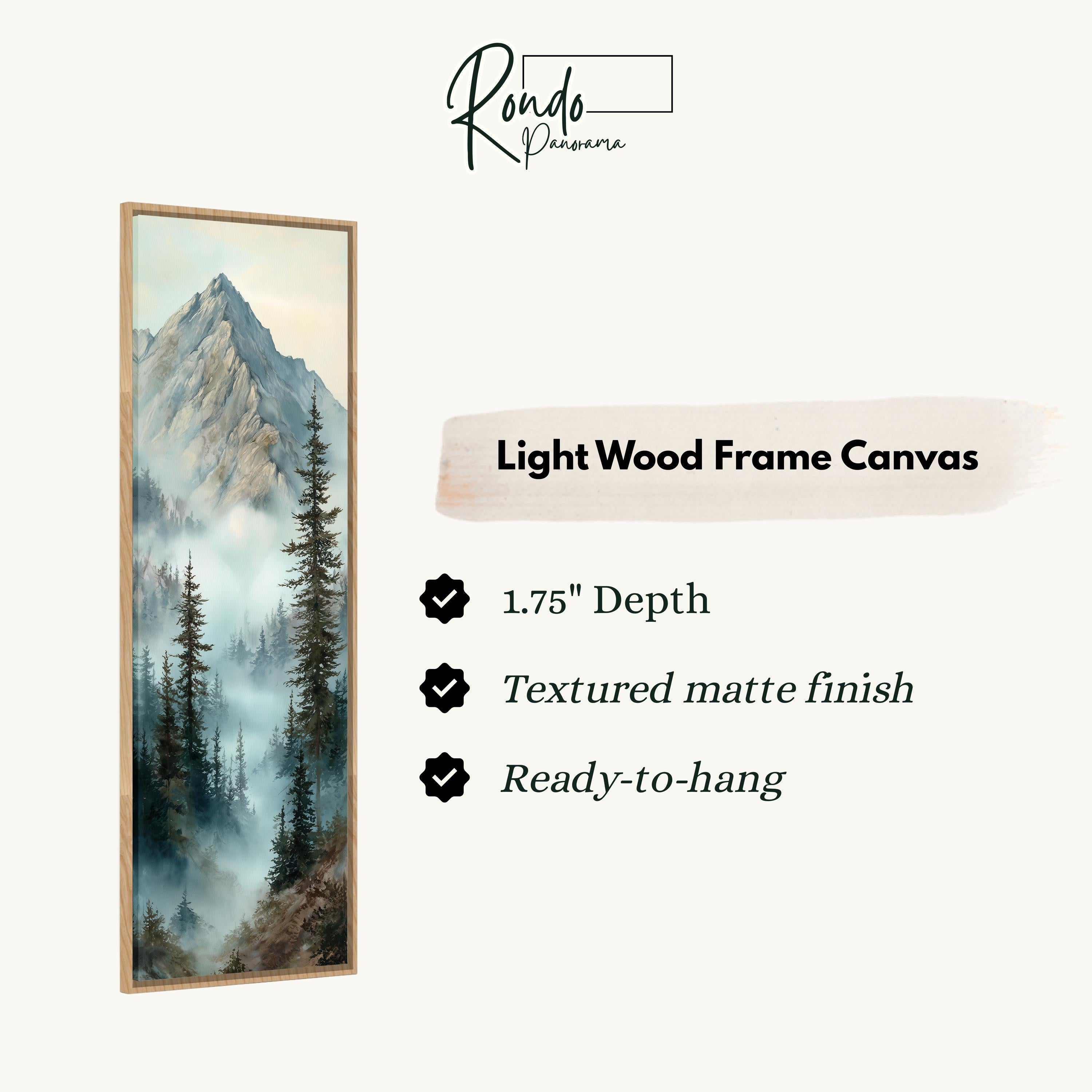 The image is a light wood frame canvas depicting a mountain landscape with pine trees and misty mountains.