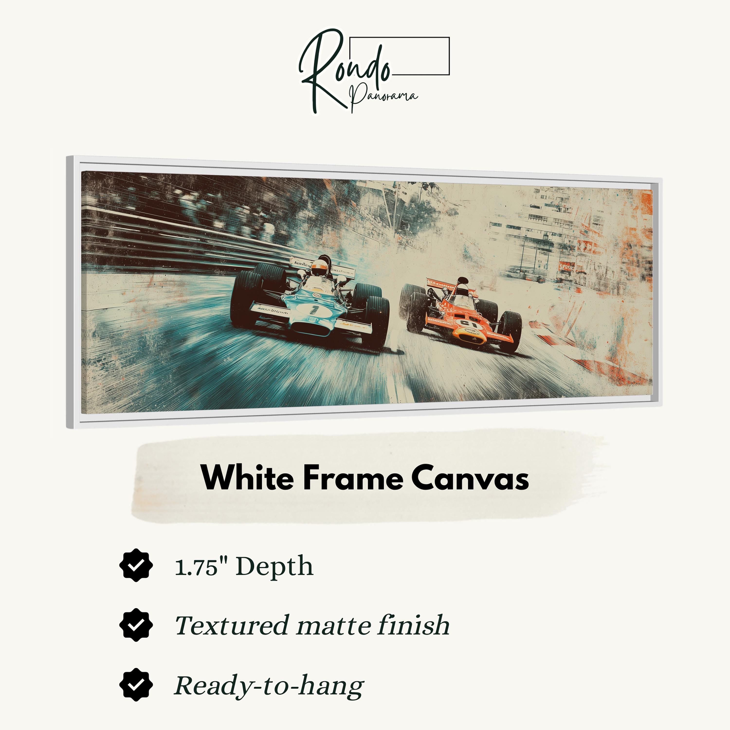 two Formula One race cars speeding down a racetrack, with a white frame canvas hanging on a wall.