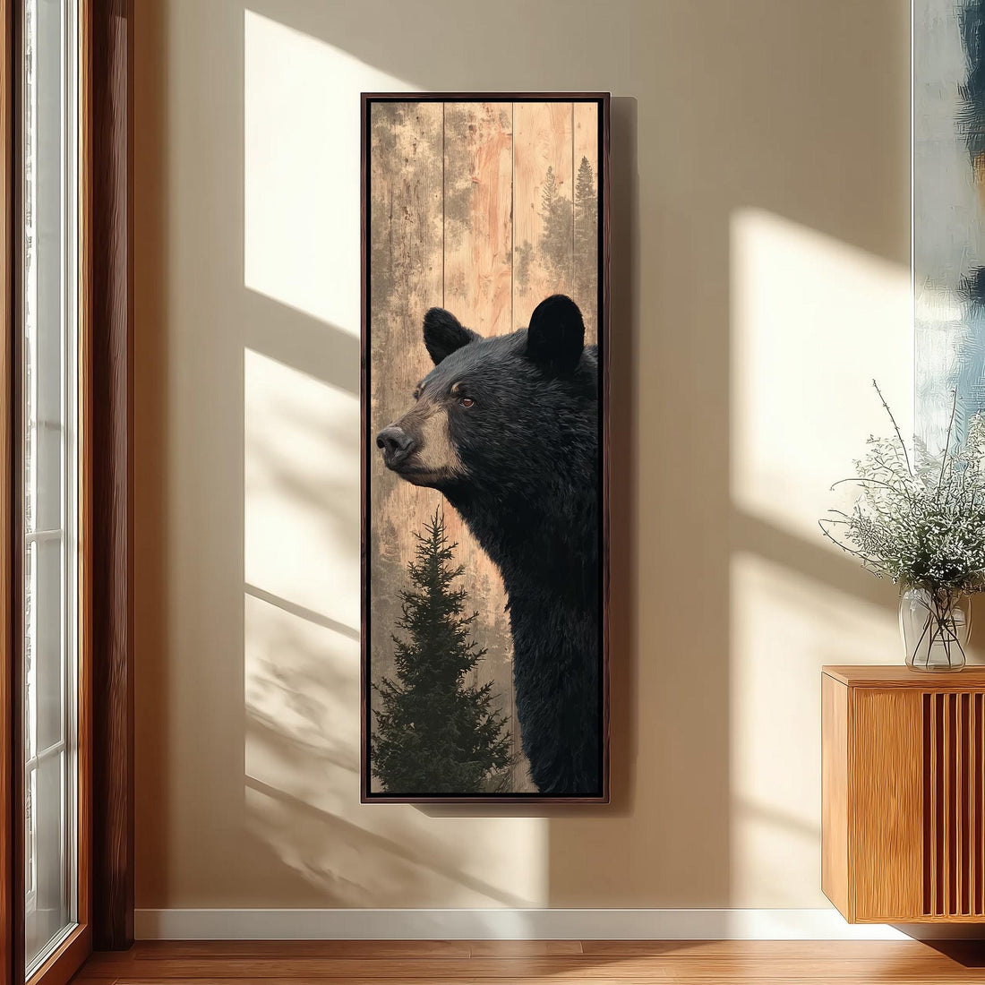 a large black bear in a wooden frame, hanging on a wall in a hallway.