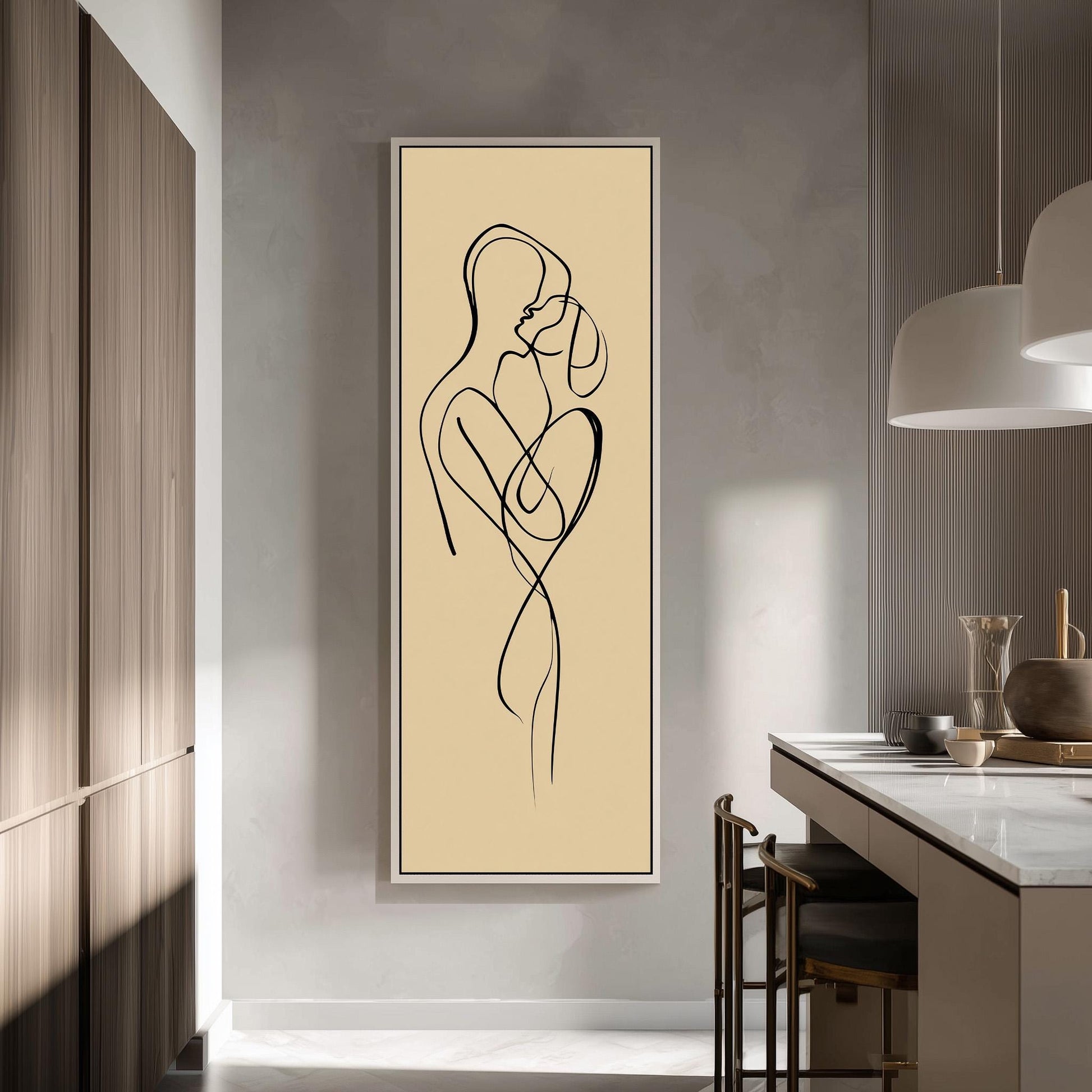 a modern kitchen with a minimalist design. The focal point is a large abstract drawing of a couple embracing, which is displayed on the wall above a kitchen counter. The kitchen counter has a few items on it, including a vase and a bowl. The overall color scheme of the kitchen is neutral, with a beige wall and wooden cabinets.