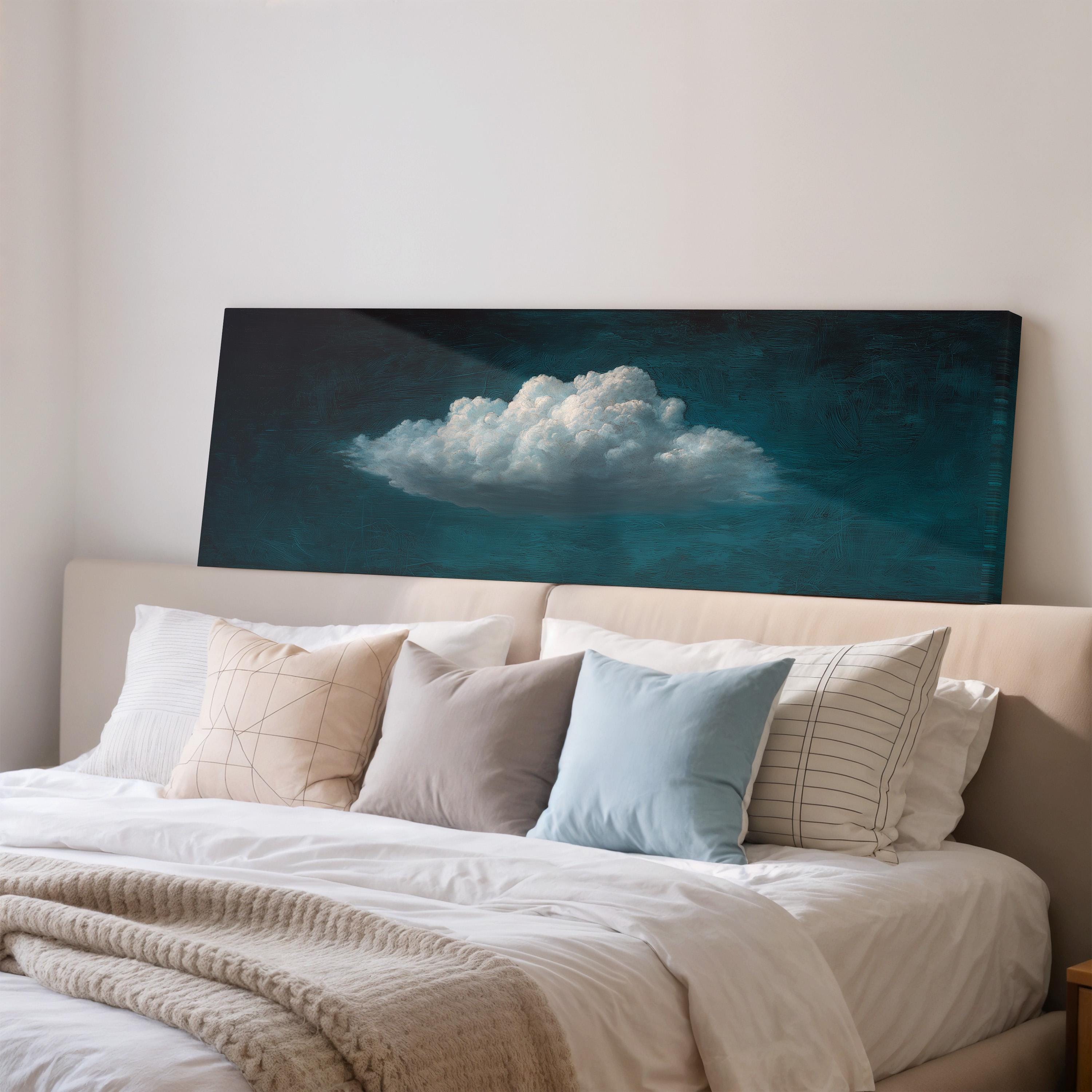 a bedroom with a large bed covered in white sheets and pillows. Above the bed, there is a large canvas print depicting a cloud against a dark blue background.