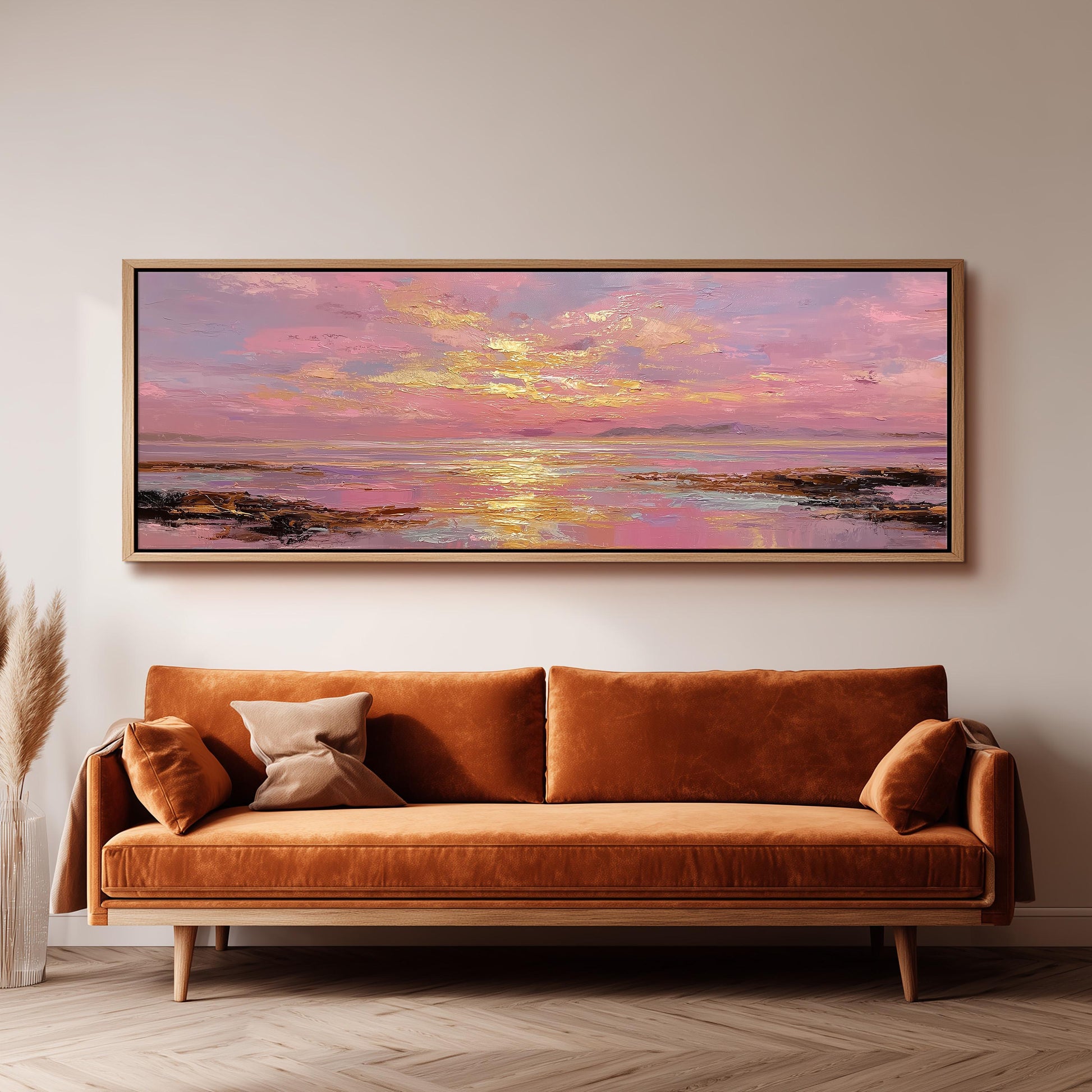 a large, rectangular painting hanging on a wall above a brown sofa.