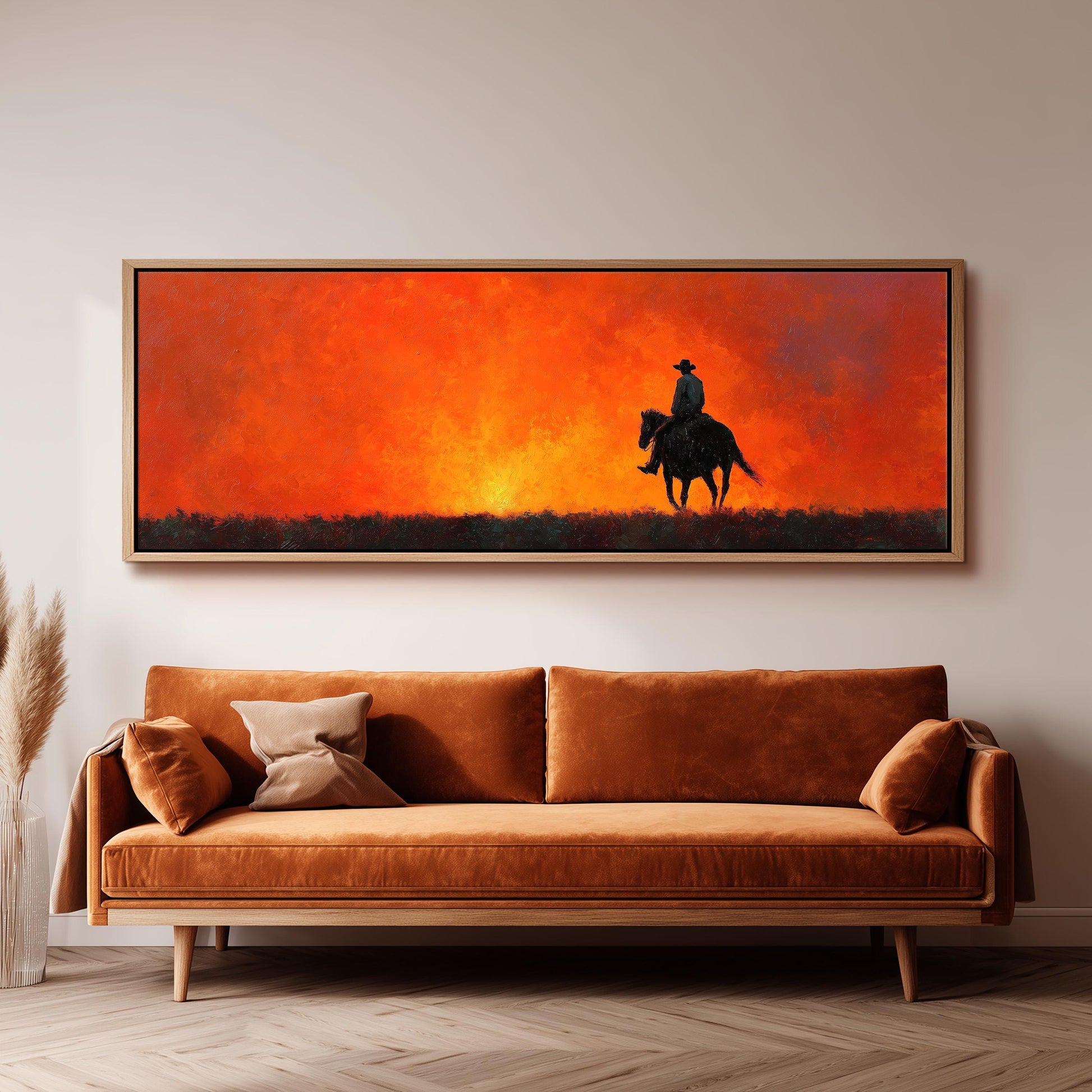 a large painting of a cowboy riding a horse, depicting a serene landscape with a sunset in the background.