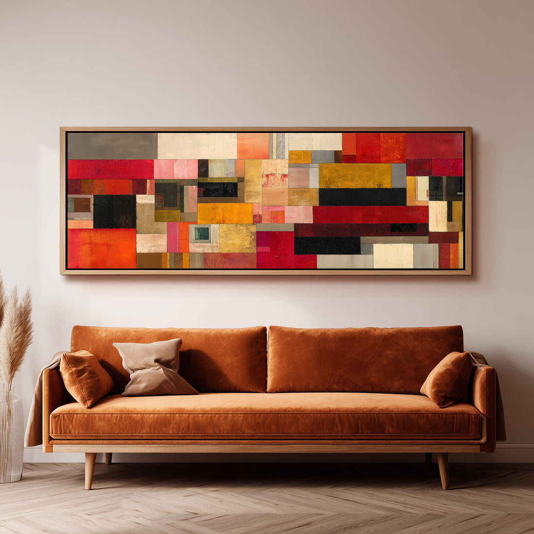 a large, abstract painting hanging on a wall above a brown sofa in a living room setting.
