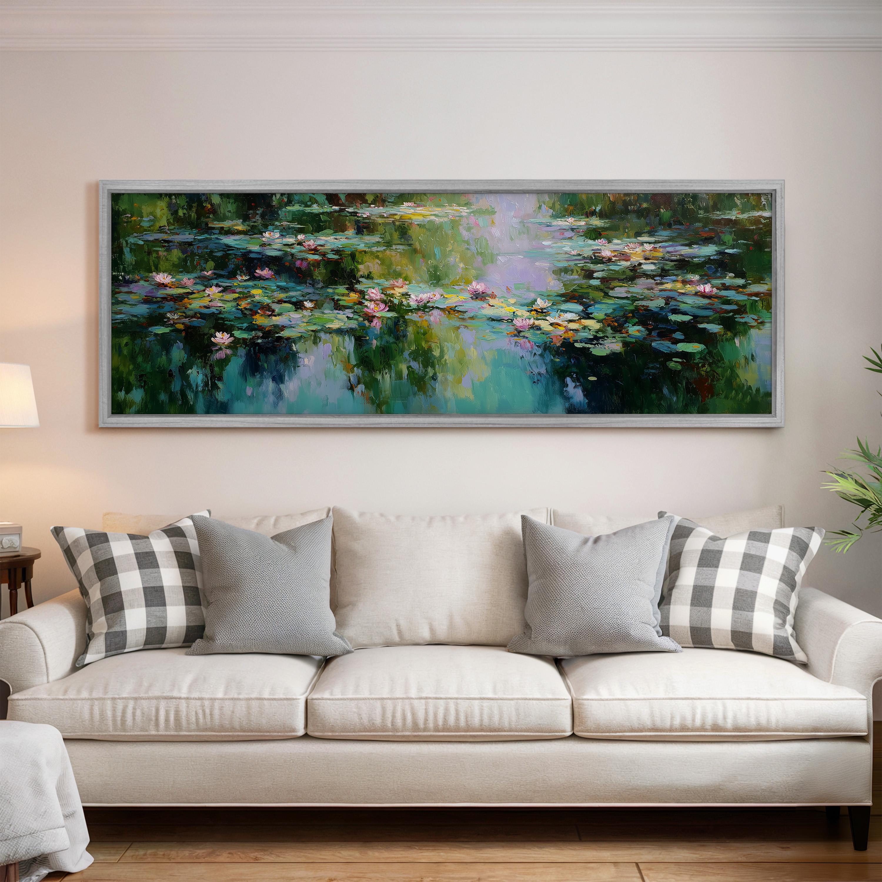 a large painting of a pond with lily pads hanging on a wall above a white sofa with gray and white patterned pillows.