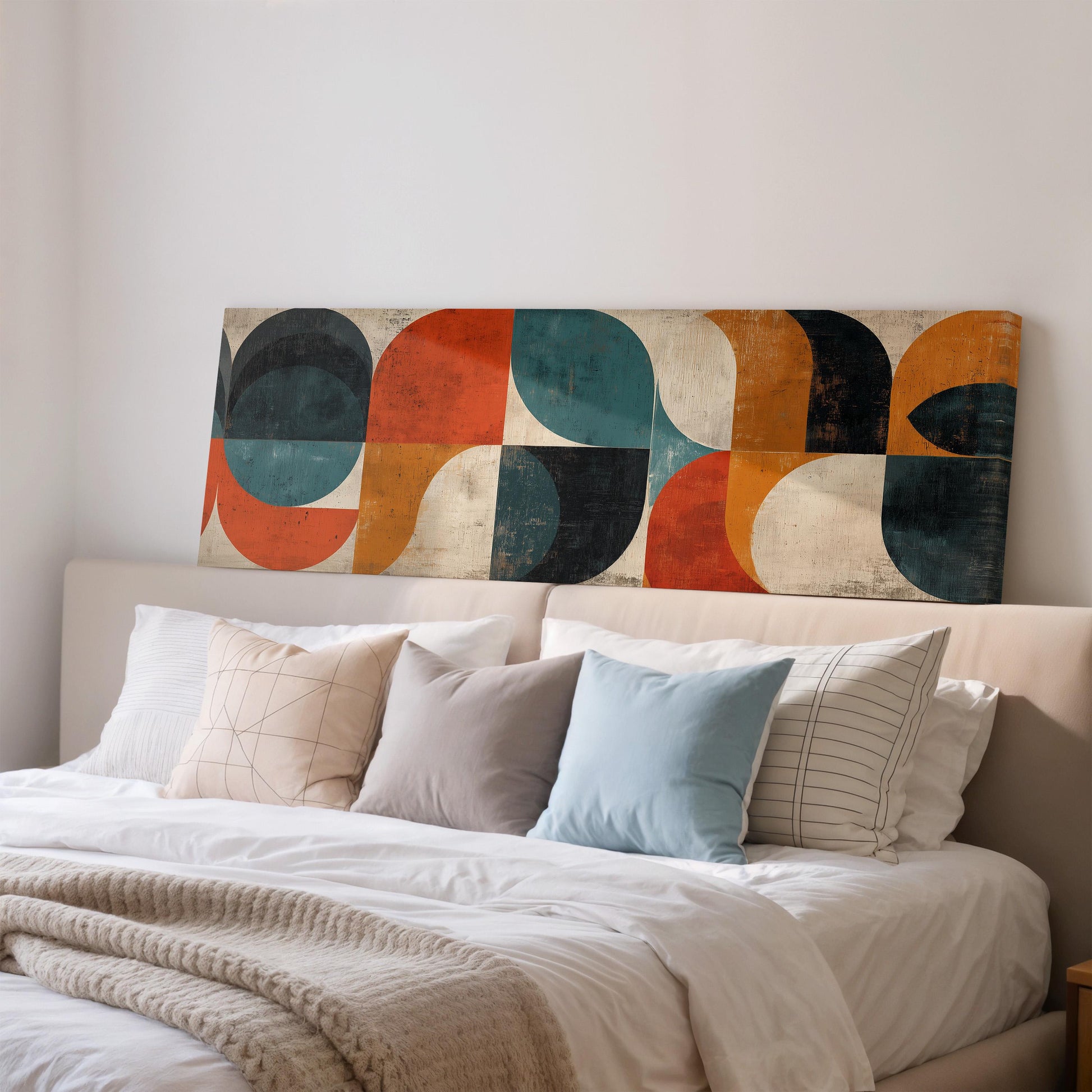 a modern bedroom with a large abstract painting on the wall above a bed with white bedding and colorful throw pillows.