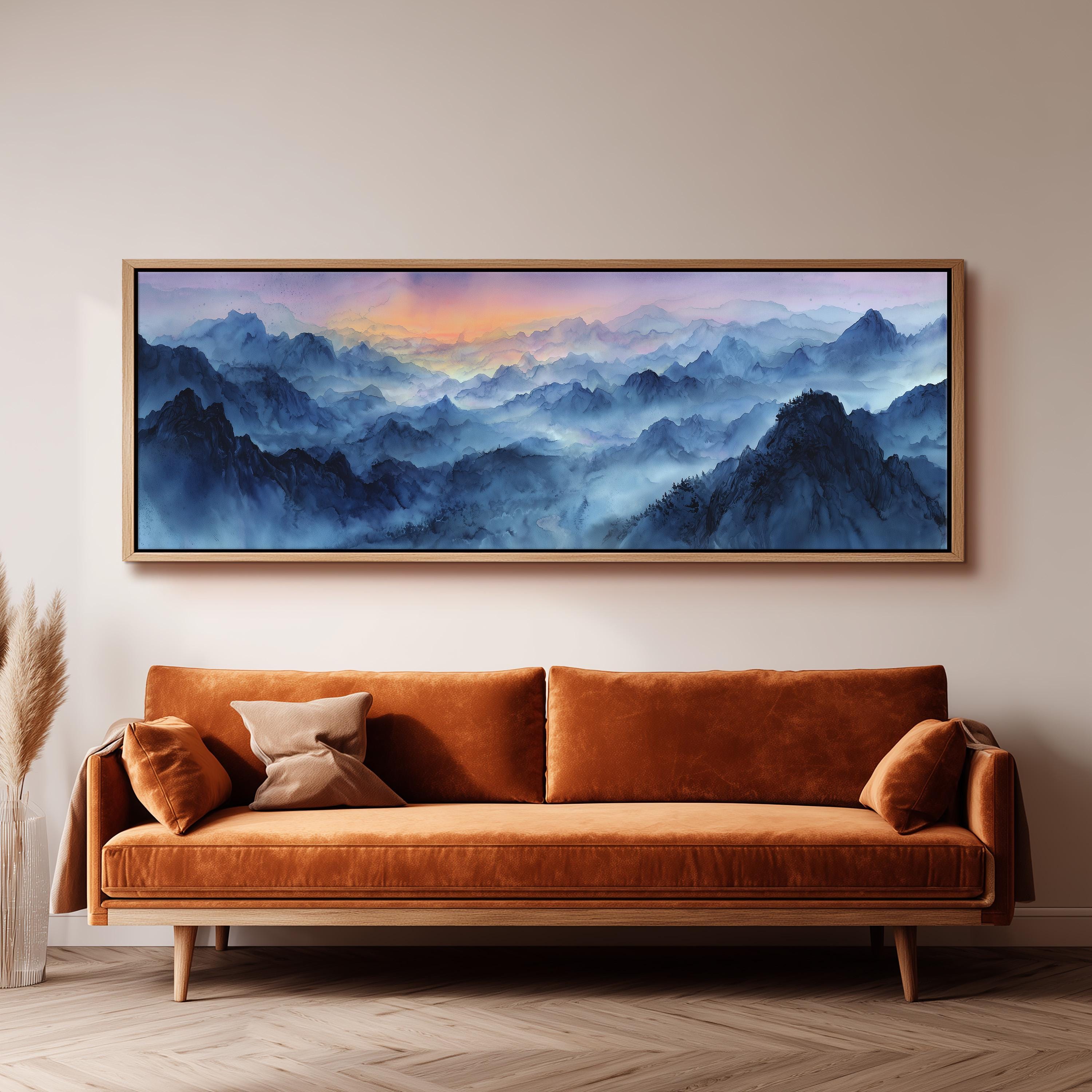 a large, framed painting of a mountainous landscape hanging on a wall above a brown sofa.