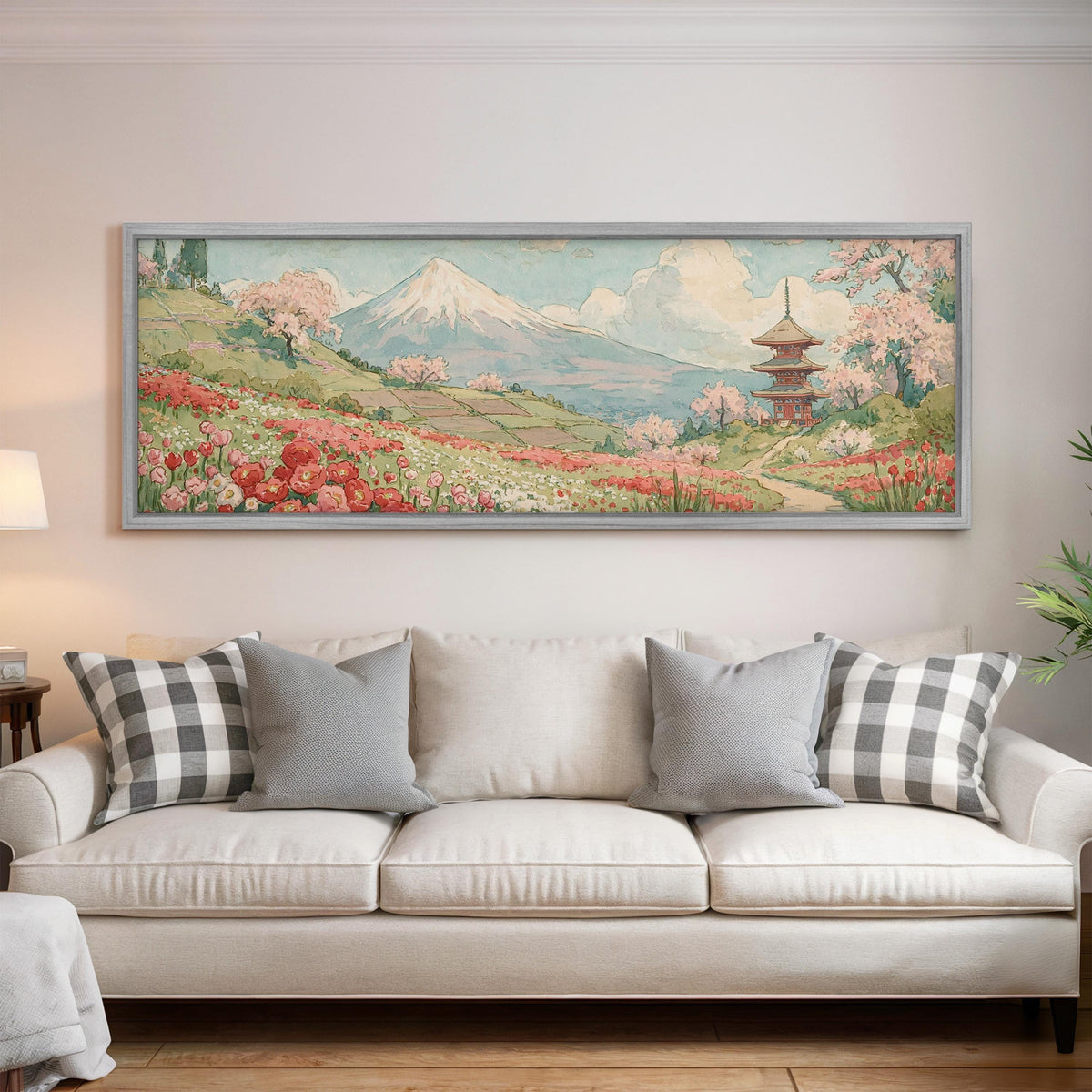 Mount Fuji with sakura and a pagoda panoramic canvas print above a white sofa in a bright living room