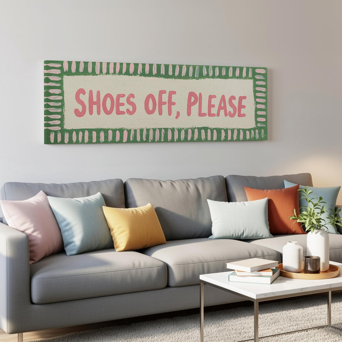 Shoes off, please sign panoramic canvas print above a grey sofa in a living room