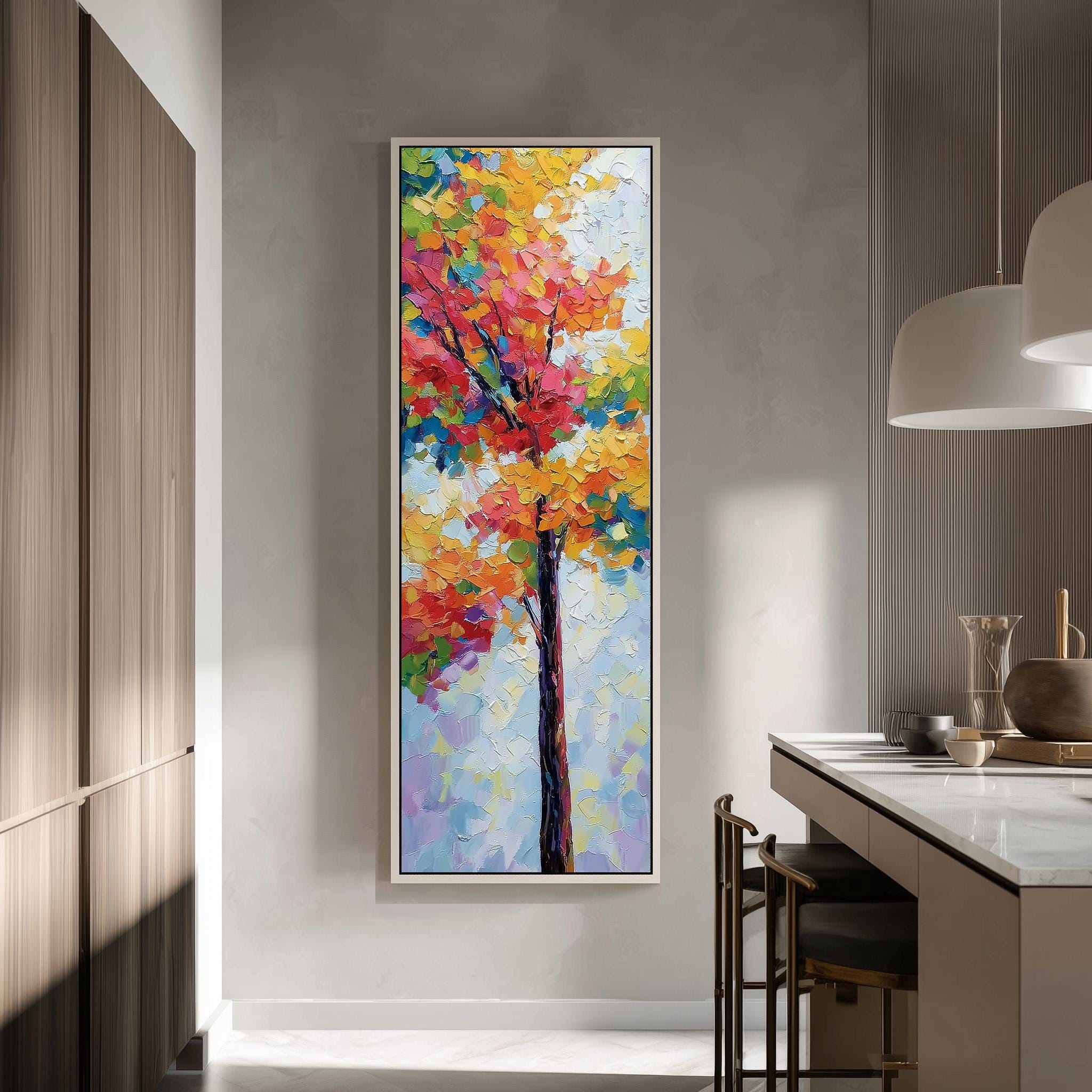 a large, colorful painting of a tree hanging on a wall in a modern kitchen.