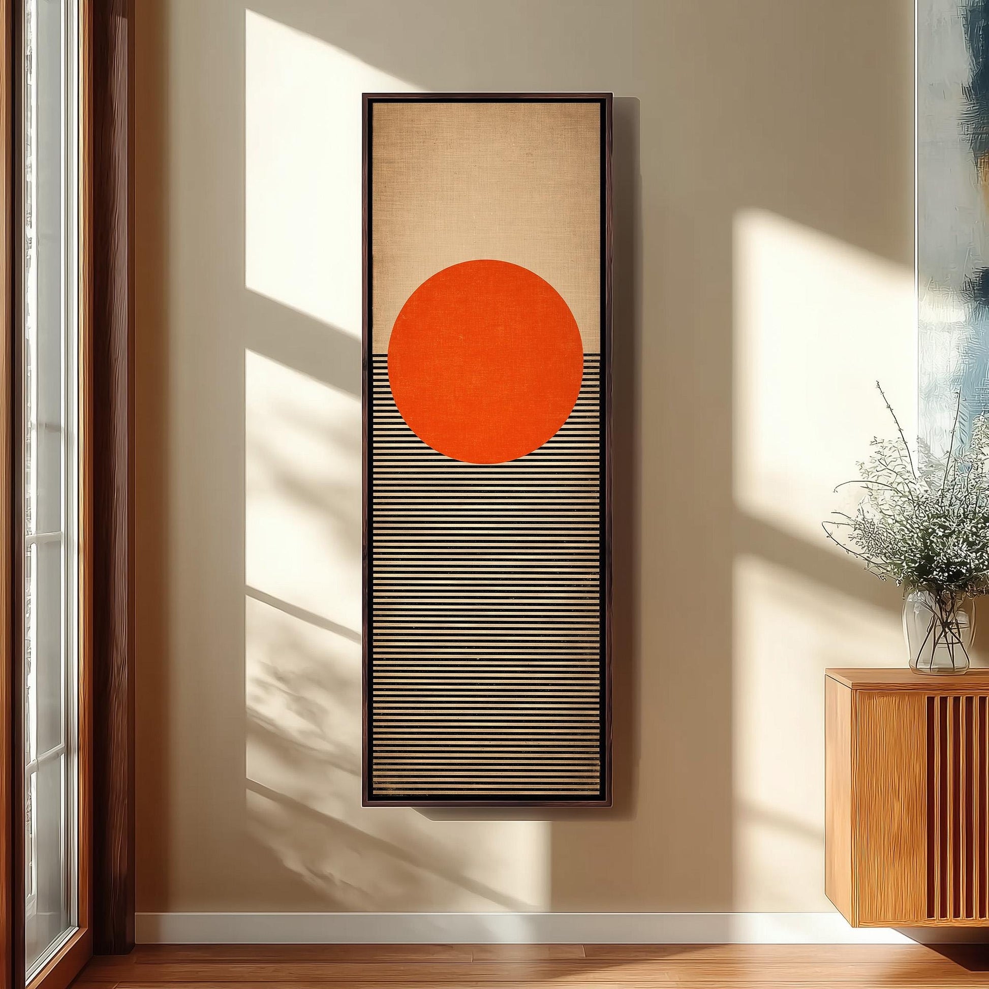 a large abstract painting hanging on a wall, with a striking orange circle and black and white striped background.