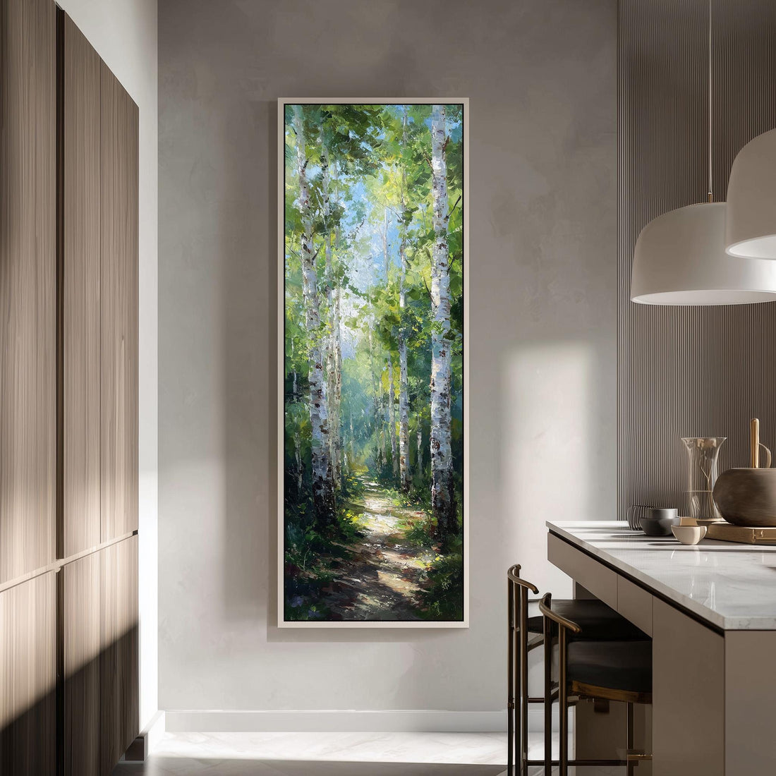 a large painting of a forest path with tall trees and a clear blue sky in the background, hanging on a wall in a modern kitchen.