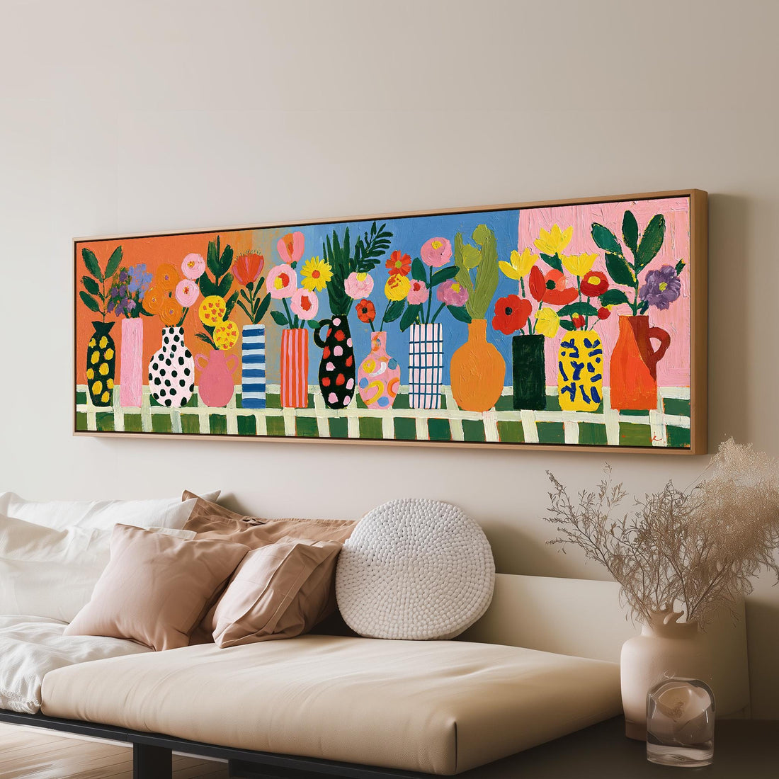 Patterned vases with bright bouquets long horizontal canvas print above a sofa in a living room