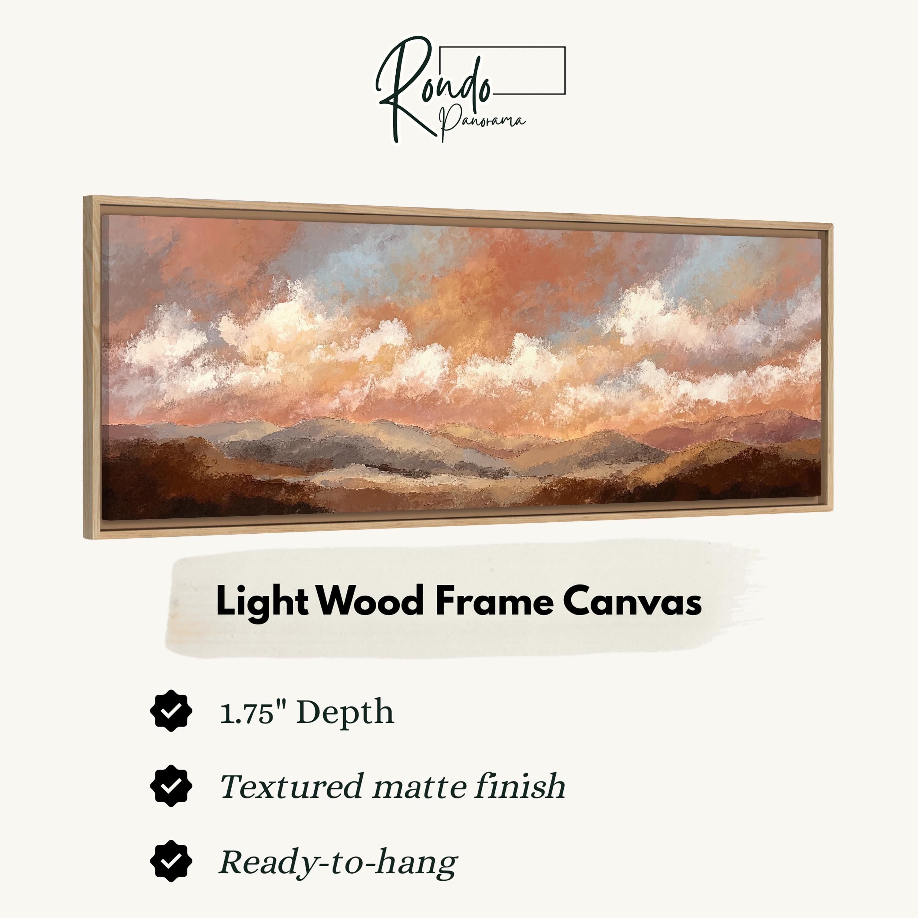 The image is a light wood frame canvas depicting a landscape with mountains and clouds.