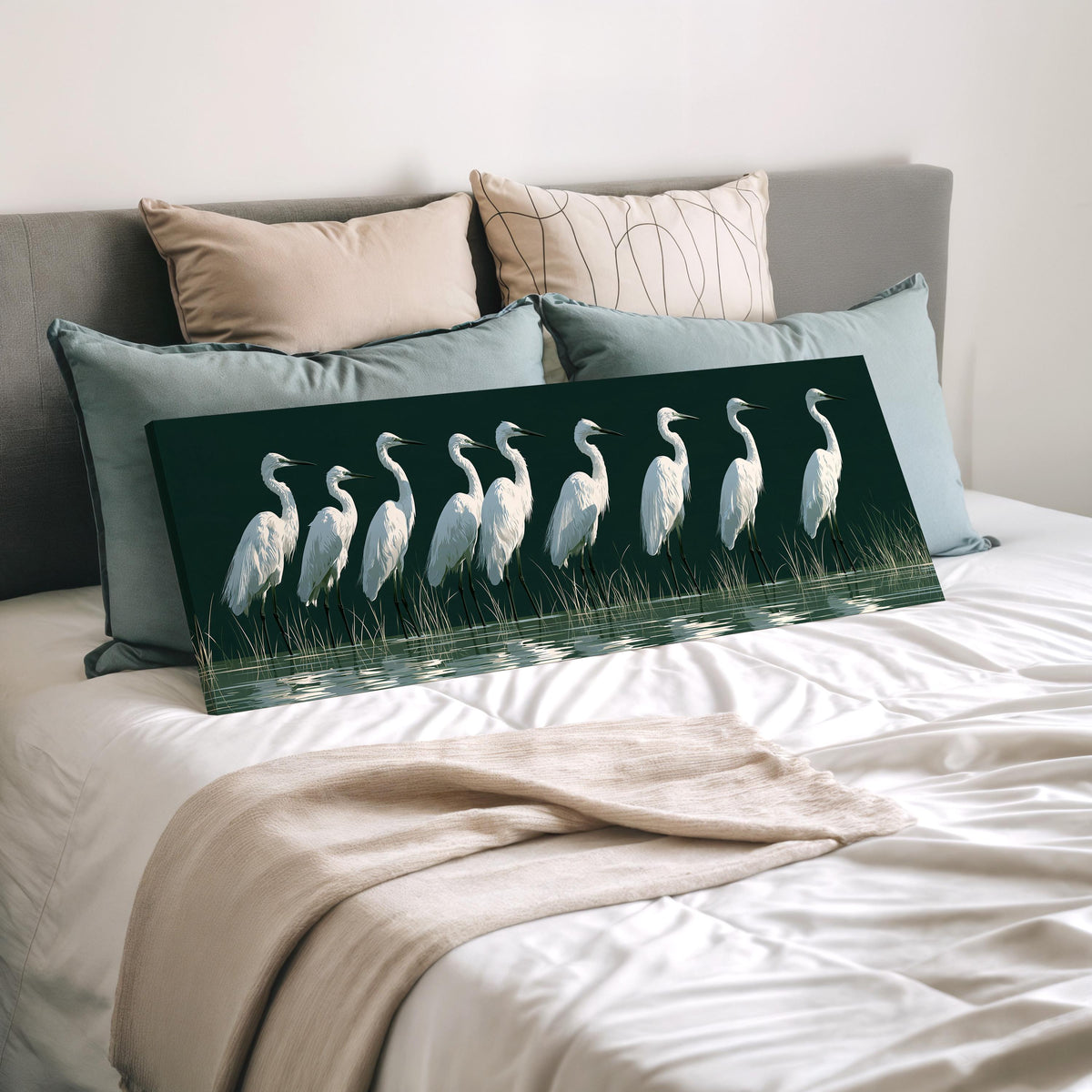 Row of white egrets on deep green wide panoramic canvas print laid on a bed to show its size