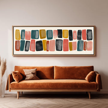 a large abstract painting hanging on a wall above a brown sofa with two pillows.