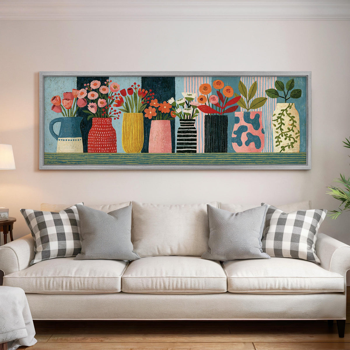 Row of folk art flower vases panoramic canvas print above a white sofa in a bright living room